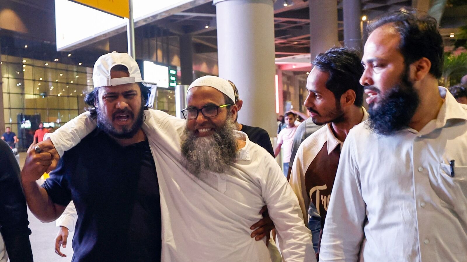 7/11 Mumbai blasts:  Shaikh Mohammed Ali Alam Shaikh, centre, one of the persons acquitted by the Bombay High Court in the 7/11 Mumbai train blasts case on Monday, being received by family and friends upon his arrival at the airport, in Mumbai, Tuesday, July 22, 2025.