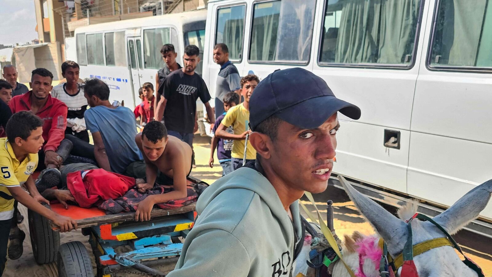 Palestinians transport people who were killed or injured while trying to get humanitarian aid, into the Red Cross field hospital in the Mawasi area of Rafah in the southern Gaza Strip on July 20, 2025.