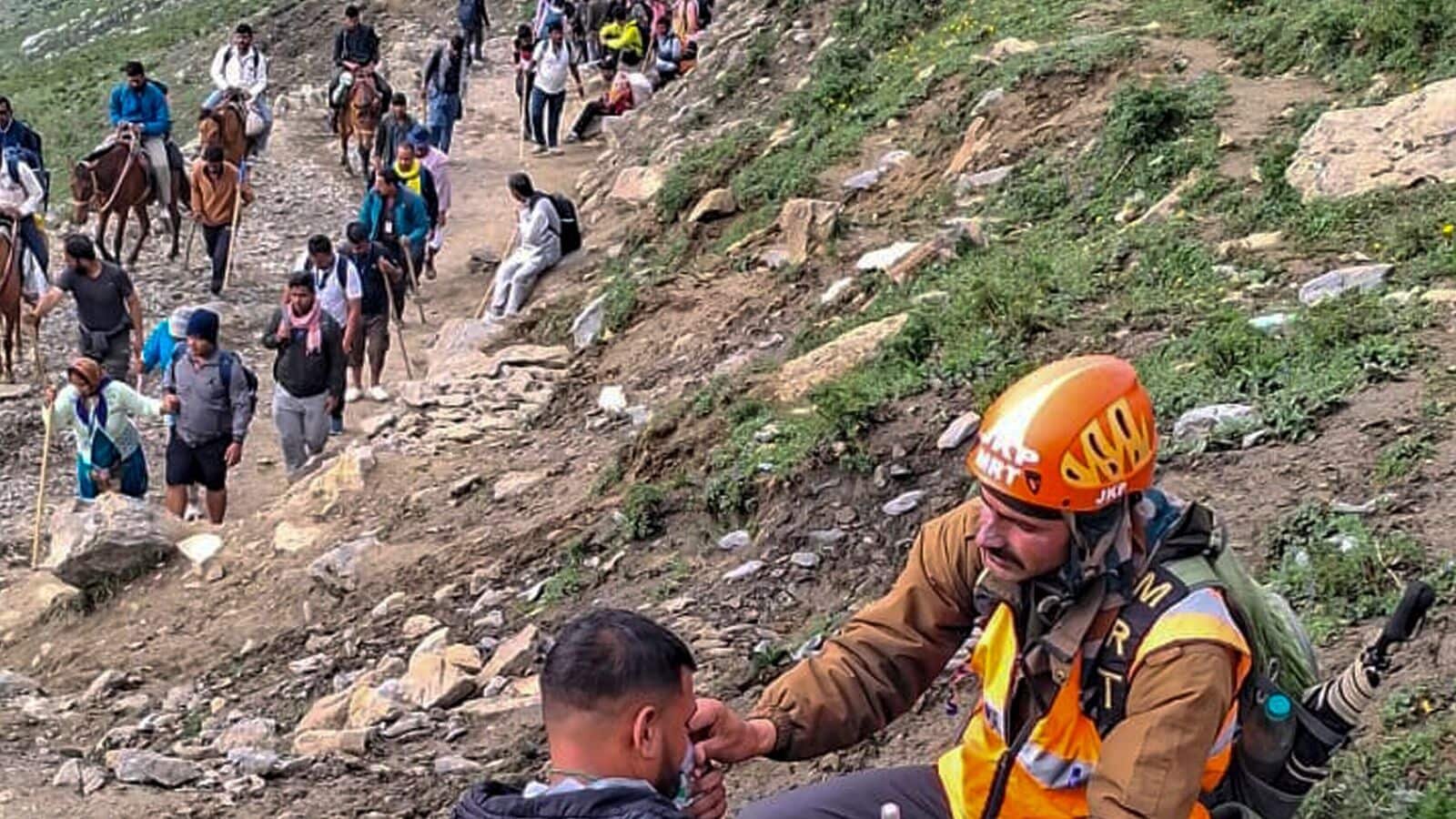 Anantnag: A member of the Mountain Rescue Teams (MRT) provides supplemental oxygen to a pilgrim at Poshpatri during the annual Amarnath Yatra, in Anantnag district, Jammu and Kashmir,