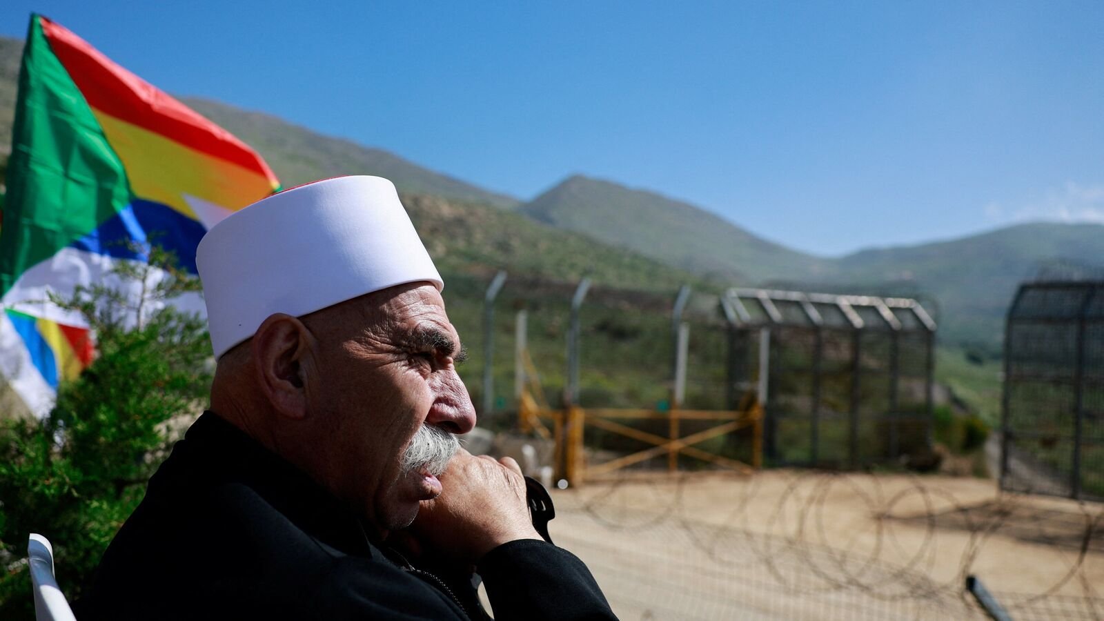 Israeli Druze man waits to greet Syrian Druze who cross the border from Syria into the Israeli-occupied Golan Heights, as they come to the annual gathering at the Nabi Shuayb Shrine, a holy place for the Druze community, at Majdal Shams, April 25, 2025. REUTERS/Ammar Awad