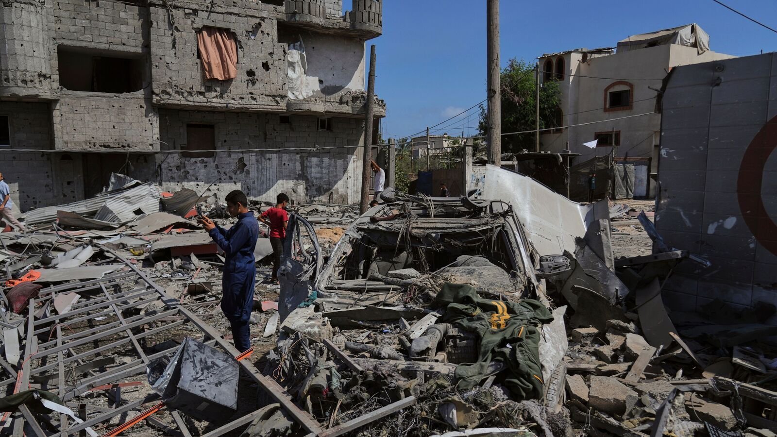 Palestinians inspect the wreckage of a gas station destroyed in an Israeli airstrike in Deir al-Balah, central Gaza Strip, Saturday, July 12, 2025. (AP Photo/Abdel Kareem Hana)