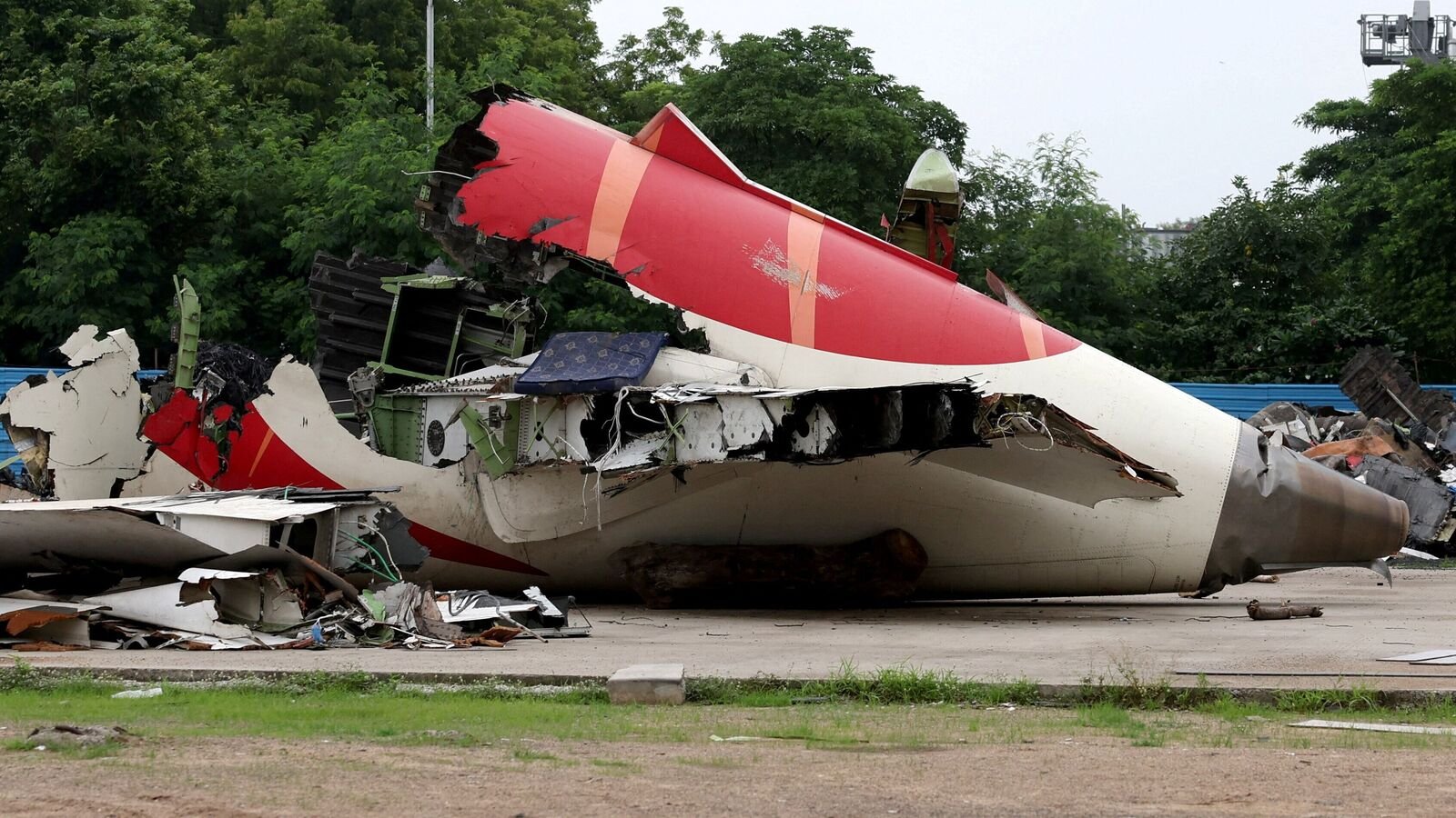 Wreckage of the Air India Boeing 787-8 Dreamliner plane sits on the open ground, outside Sardar Vallabhbhai Patel International Airport