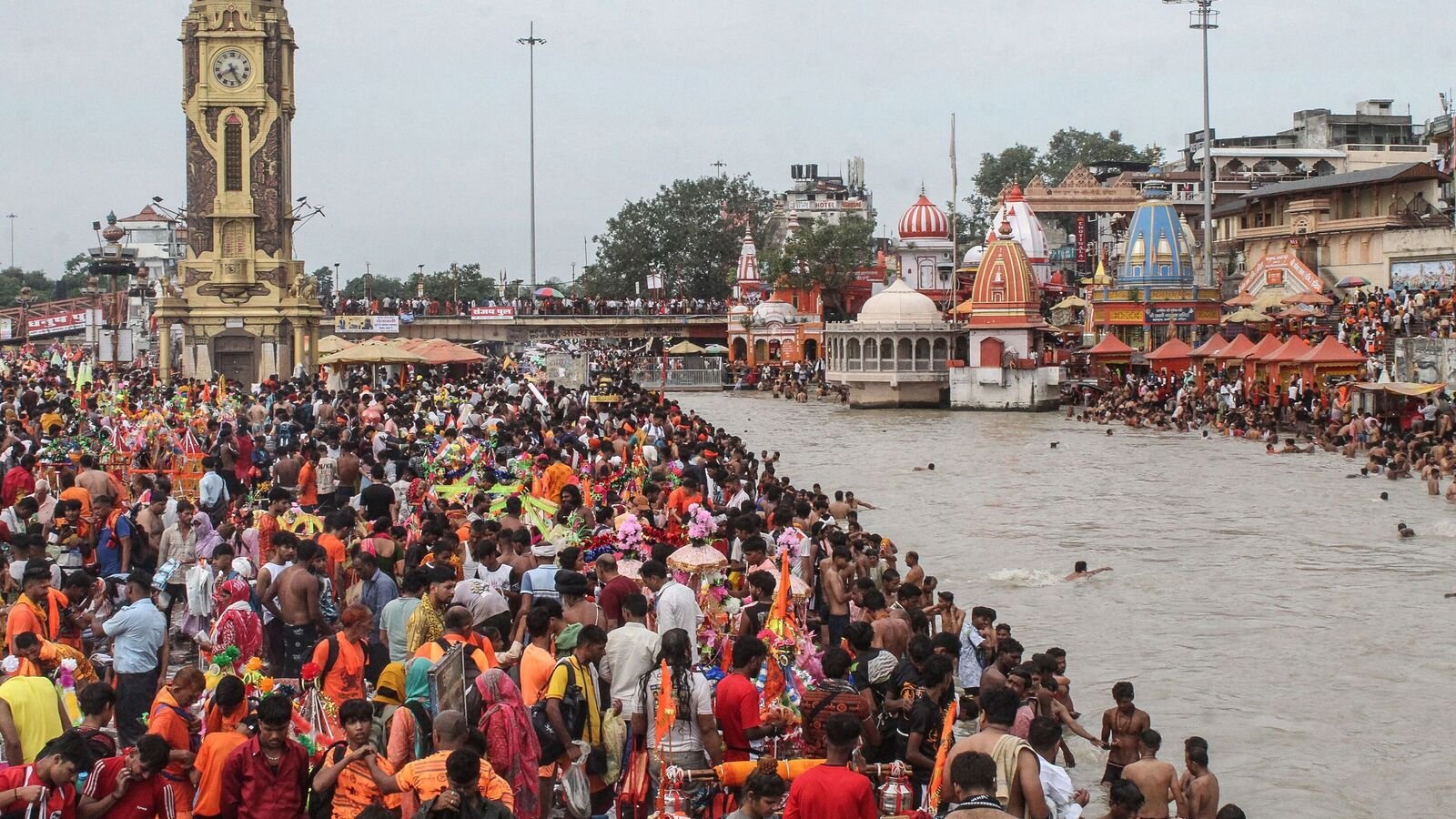 Kanwariyas gather to collect holy water from the river Ganges for the 'Kanwar Yatra' pilgrimage, at the Har Ki Pauri Ghat in Haridwar on July 14, 2025.