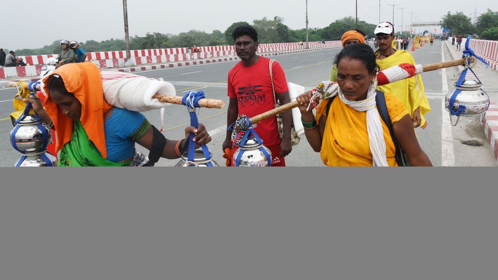 Kanwariyas return carrying Ganga water during the annual Kanwar Yatra in New Delhi on Monday. (ANI Photo)