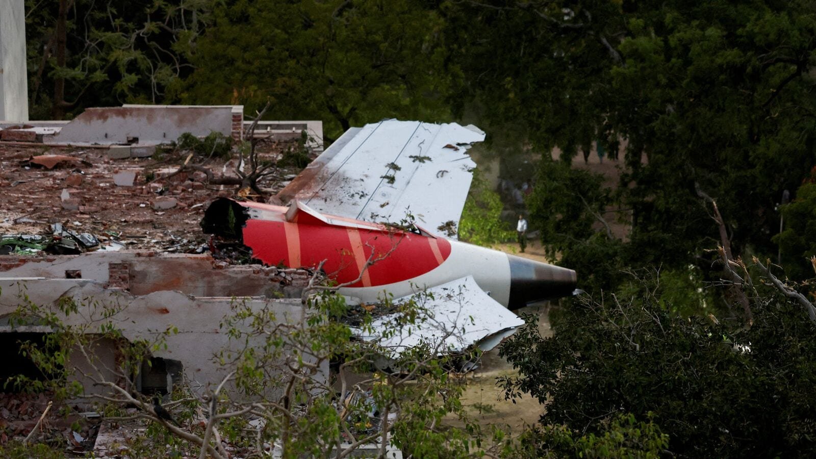 FILE PHOTO: Tail of an Air India Boeing 787 Dreamliner plane that crashed is seen stuck on a building after the incident in Ahmedabad, India, June 12, 2025. REUTERS/Amit Dave/File Photo