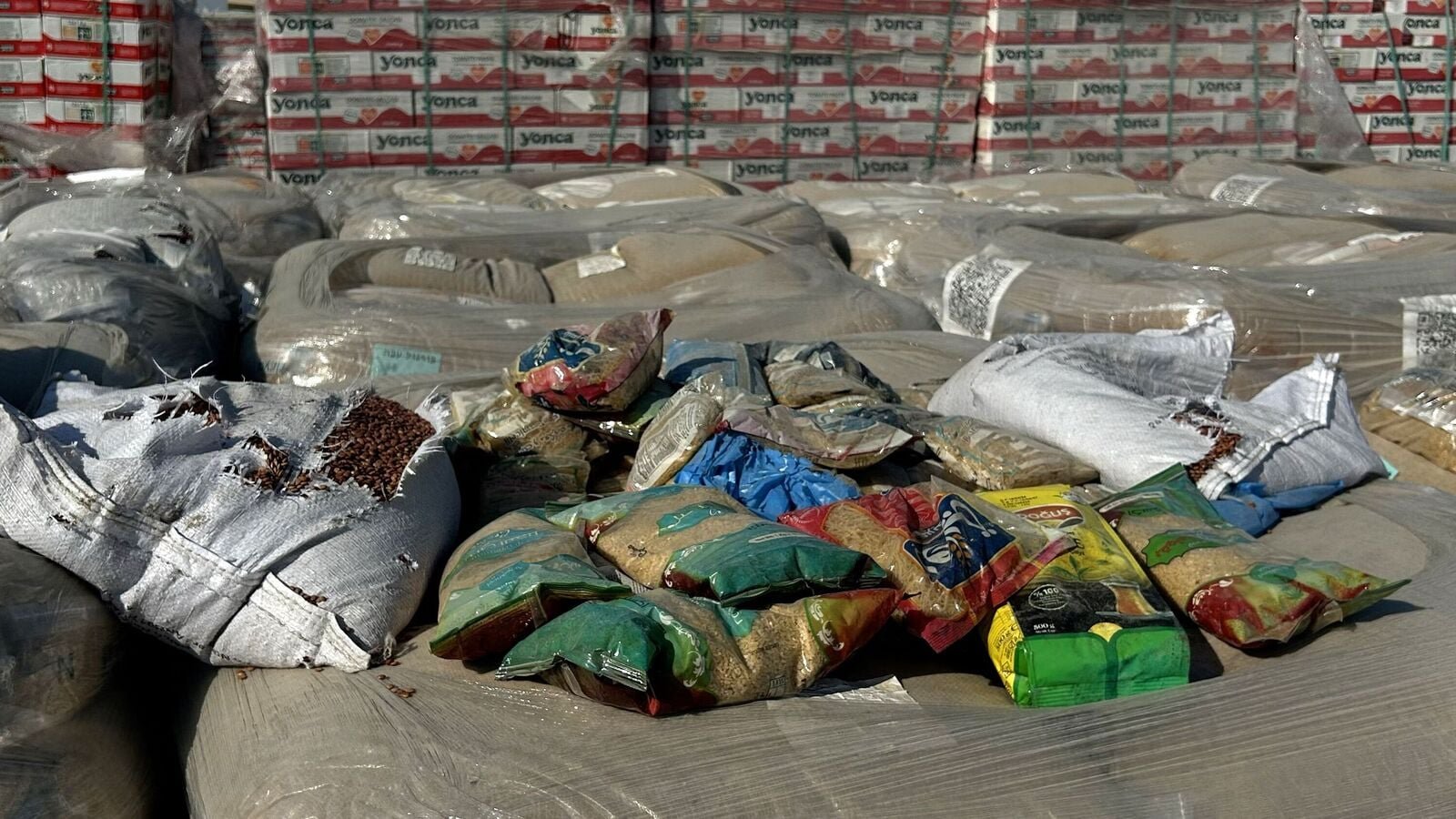 A picture shows humanitarian aid awaiting transport at the Kerem Shalom crossing between southern Israel and the Gaza Strip on July 27, 2025. (Photo by Carlos REYES / AFP)