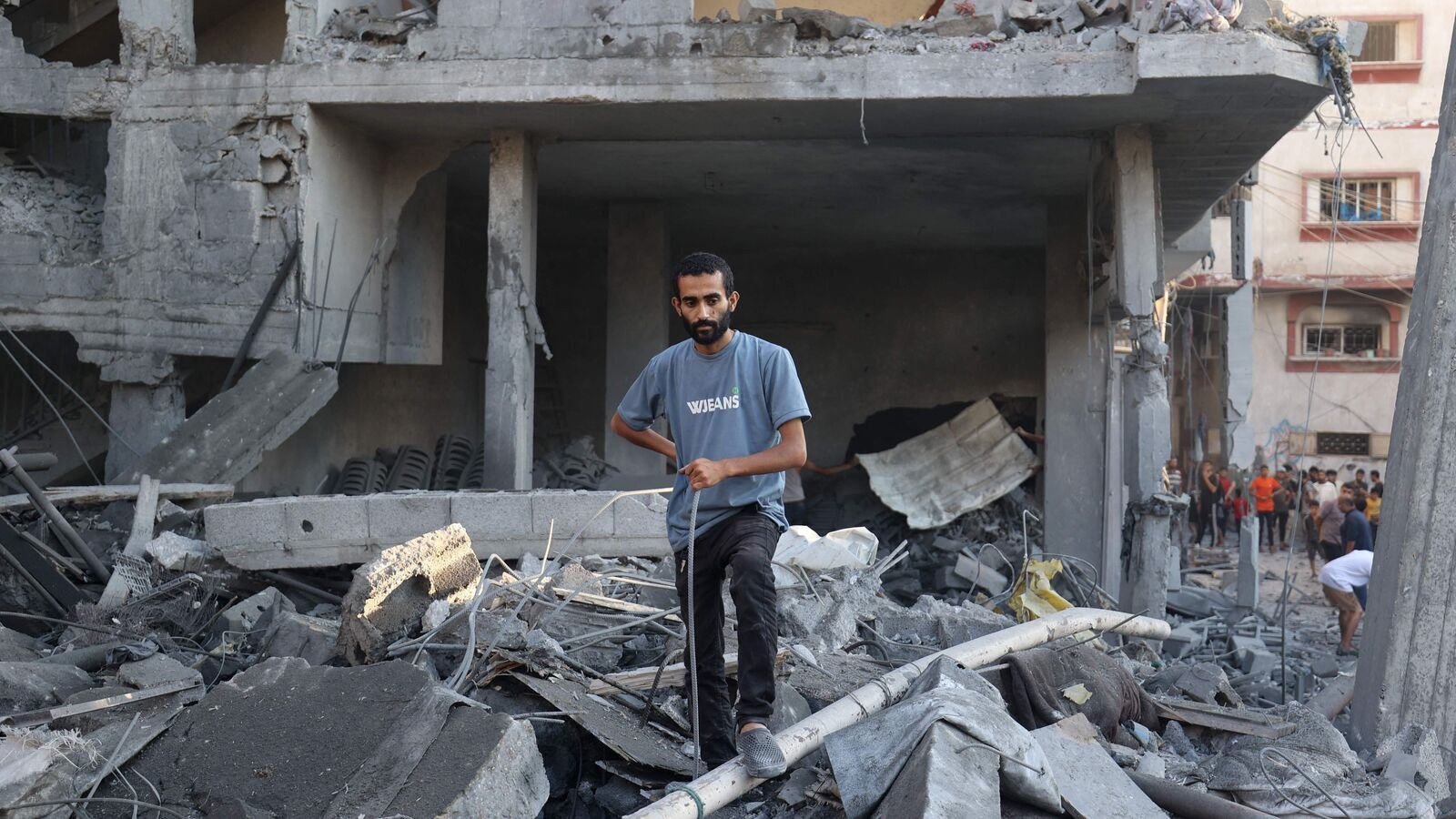 A Palestinian man inspects the damage after an Israeli strike on the Bureij refugee camp in the central Gaza Strip on July 23, 2025. More than 100 aid organisations warned on July 23, that 'mass starvation' was spreading across the Gaza Strip and that their own colleagues were suffering acutely from the shortages.