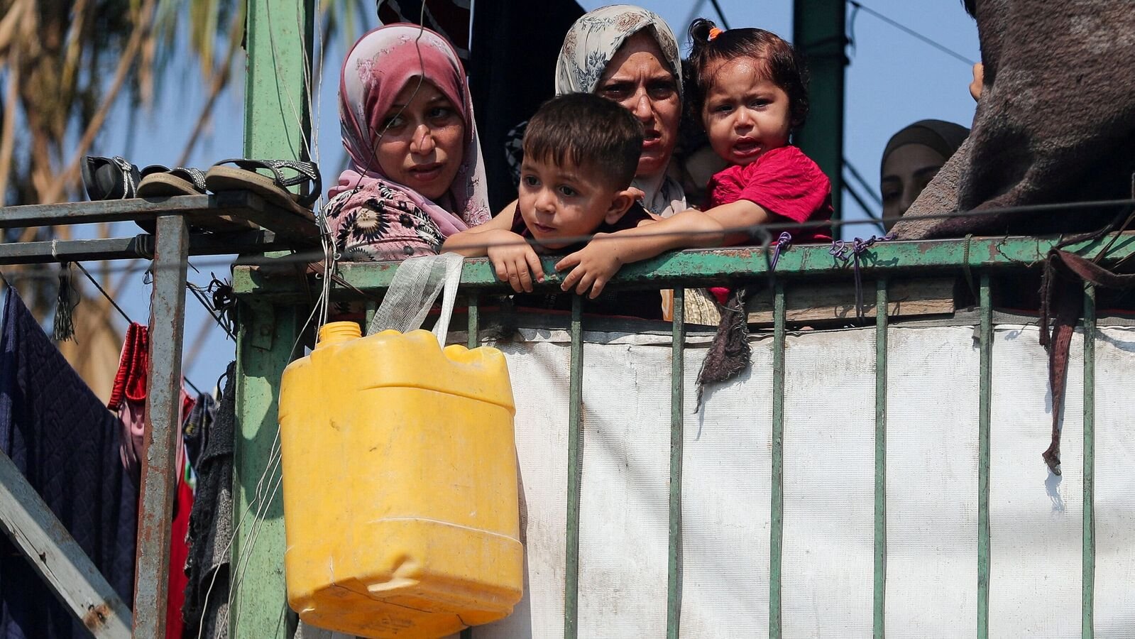 Palestinians look on at the site of an overnight Israeli strike on a school sheltering displaced families, in Jabalia, in the northern Gaza Strip, July 11, 2025. REUTERS/Mahmoud Issa