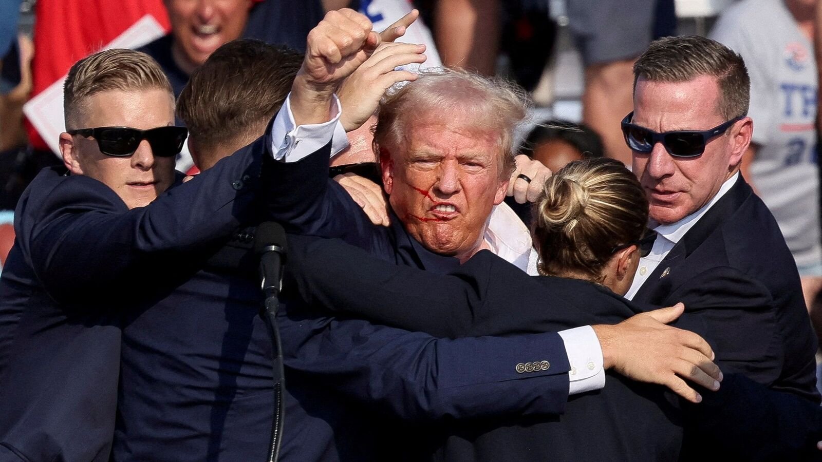 This picture shows Donald Trump is assisted by the Secret Service after gunfire rang out during a campaign rally at the Butler Farm Show in Butler, Pennsylvania, US, July 13, 2024.