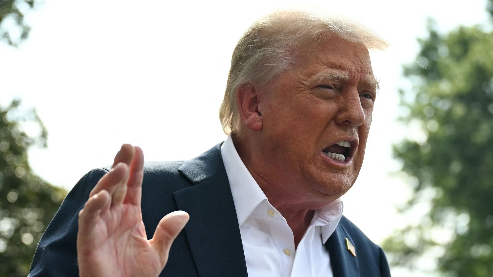 US President Donald Trump speaks to the press before boarding Marine One on the South Lawn of the White House in Washington, DC, on July 11, 2025. President Donald Trump on July 12, 2025