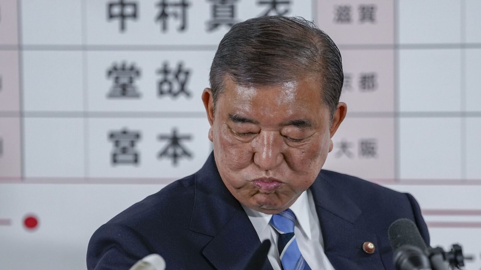 Shigeru Ishiba, Japan's prime minister and president of the Liberal Democratic Party (LDP), drinks water at the party's headquarters following the upper house election in Tokyo, Japan on Sunday, July 20, 2025. Japan's ruling coalition looked set to lose its majority in the upper house, according to exit polls, an outcome that would further weaken embattled Prime Minister Ishiba's leadership and potentially unsettle markets. Photographer: Toru Hanai/Bloomberg