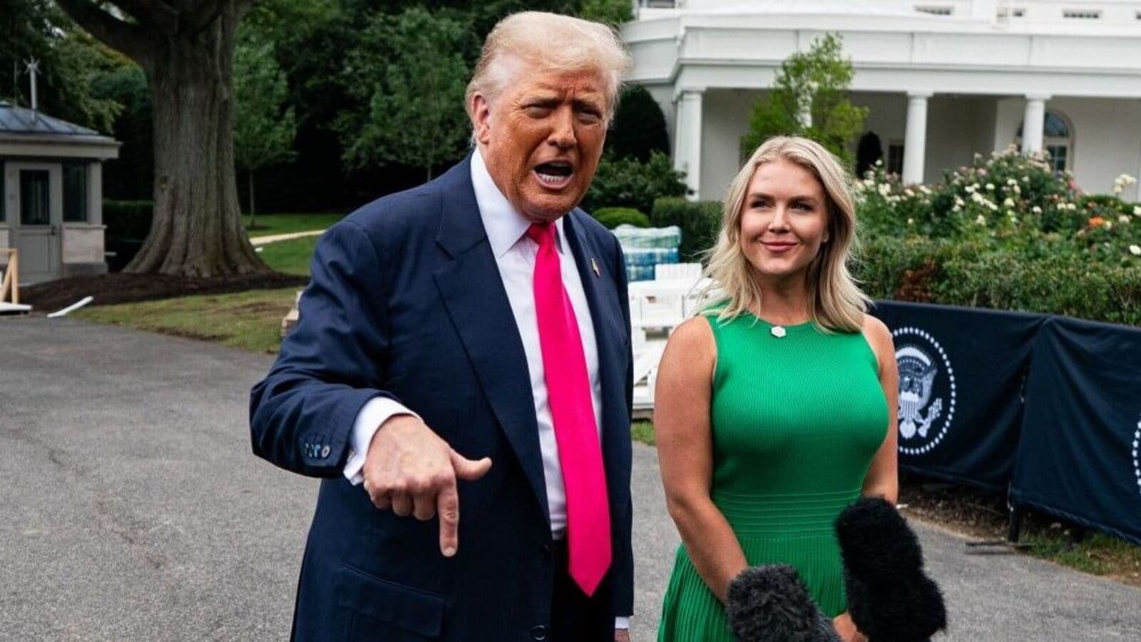 Karoline Leavitt, White House press secretary, right, watches as US President Donald Trump, speaks to members of the media on the South Lawn of the White House before boarding Marine One in Washington, DC, US, on Tuesday, July 15, 2025. Photographer: Al Drago/Bloomberg