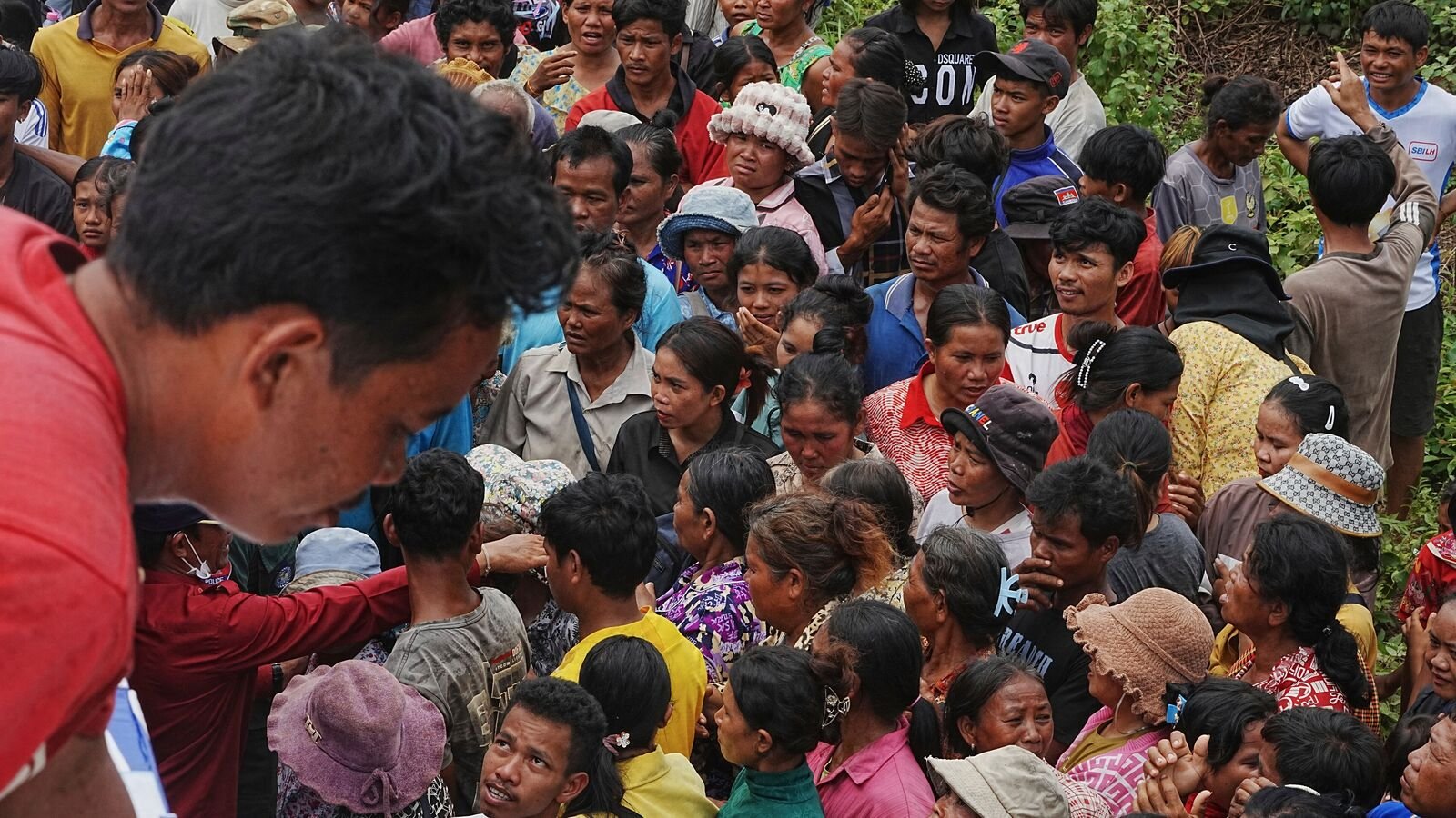 Cambodian villagers wait to receive drinking water donated by a local company as they take refuge in Batthkoa primary school in Oddar Meanchey province, Cambodia, on Saturday, July 26, 2025. Border fighting between Thailand and Cambodia entered its third day on Saturday.