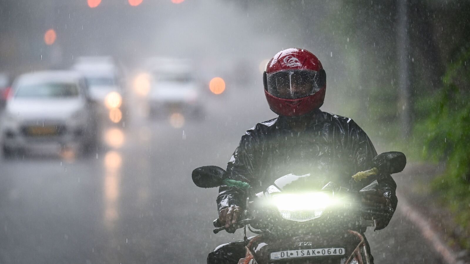 Commuters seen during massive rains at Akbar Road in New Delhi, India, on Friday, July 18, 2025.  (Photo by Sanchit Khanna/ Hindustan Times)