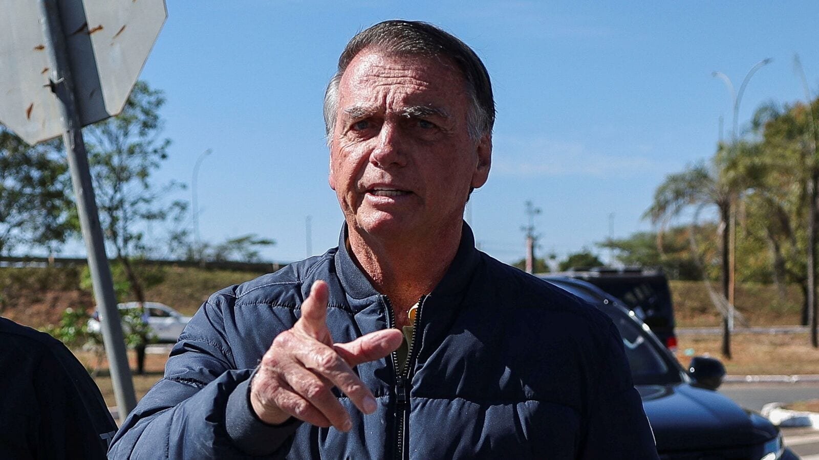 Brazil's former President Jair Bolsonaro gestures as he arrives to the State Secretariat of Penitentiary Administration headquarters in Brasilia, Brazil on July 18, 2025.