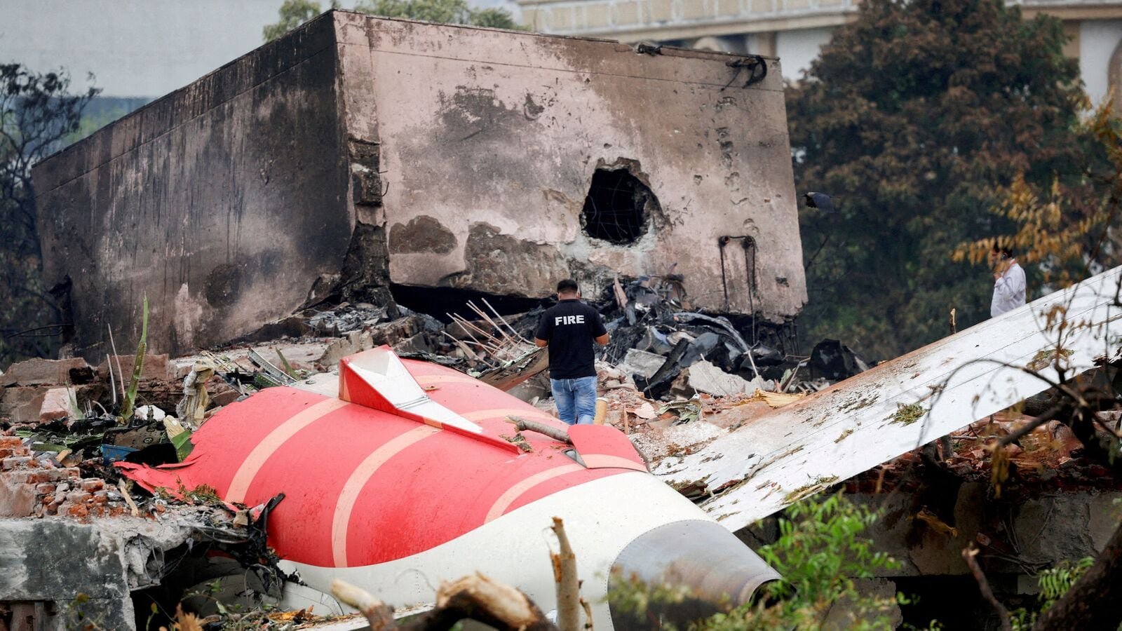 A firefighter stands next to the crashed Air India Boeing 787-8 Dreamliner aircraft, in Ahmedabad, India, June 13.