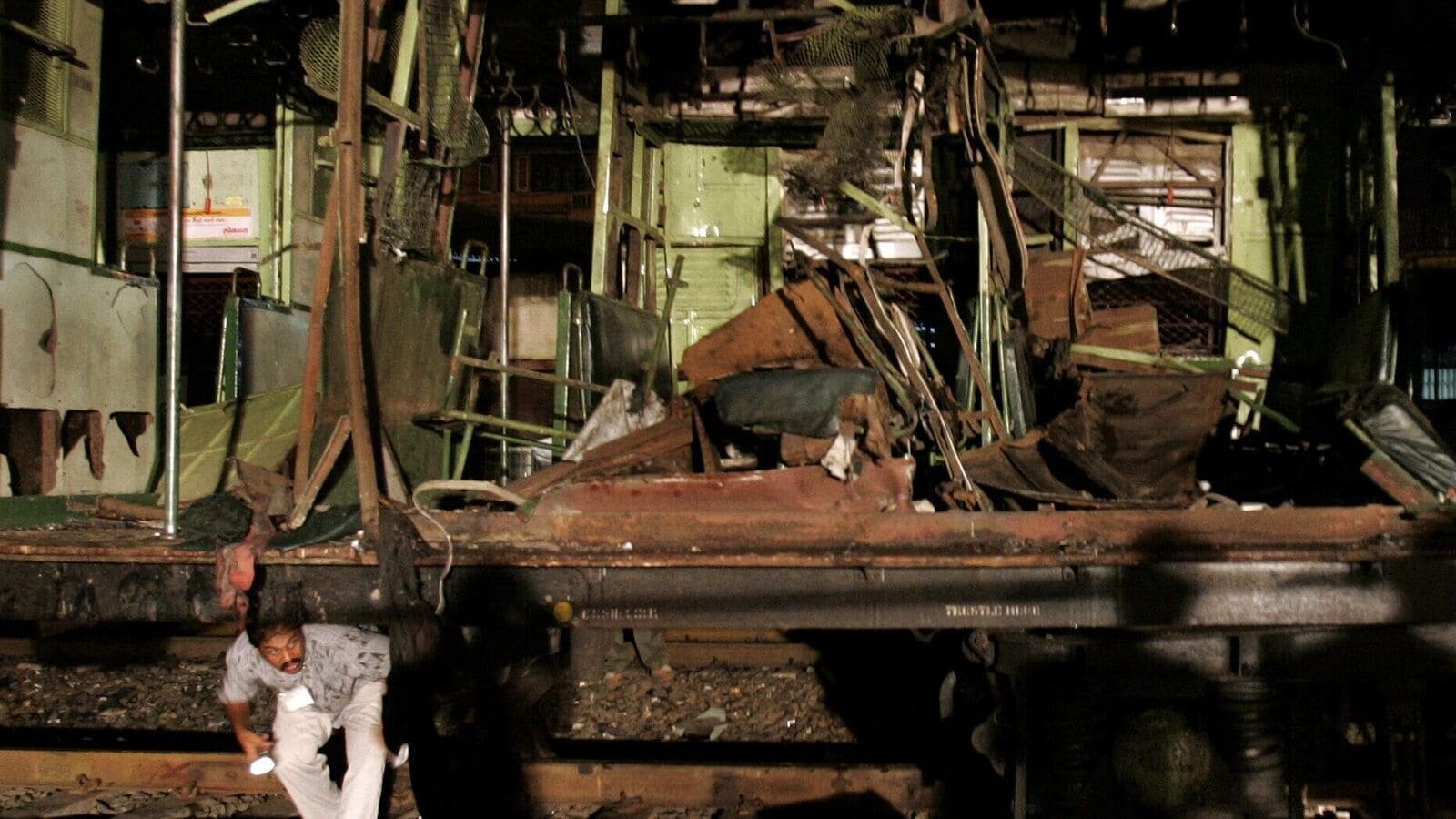 11/7 Mumbai Serial Bomb Blasts - A policeman investigates the carriage wreckage at Matunga Station after the serial train blasts that tore through Bombay on Tuesday - HT Photo : Rajanish kakade 11/07/06