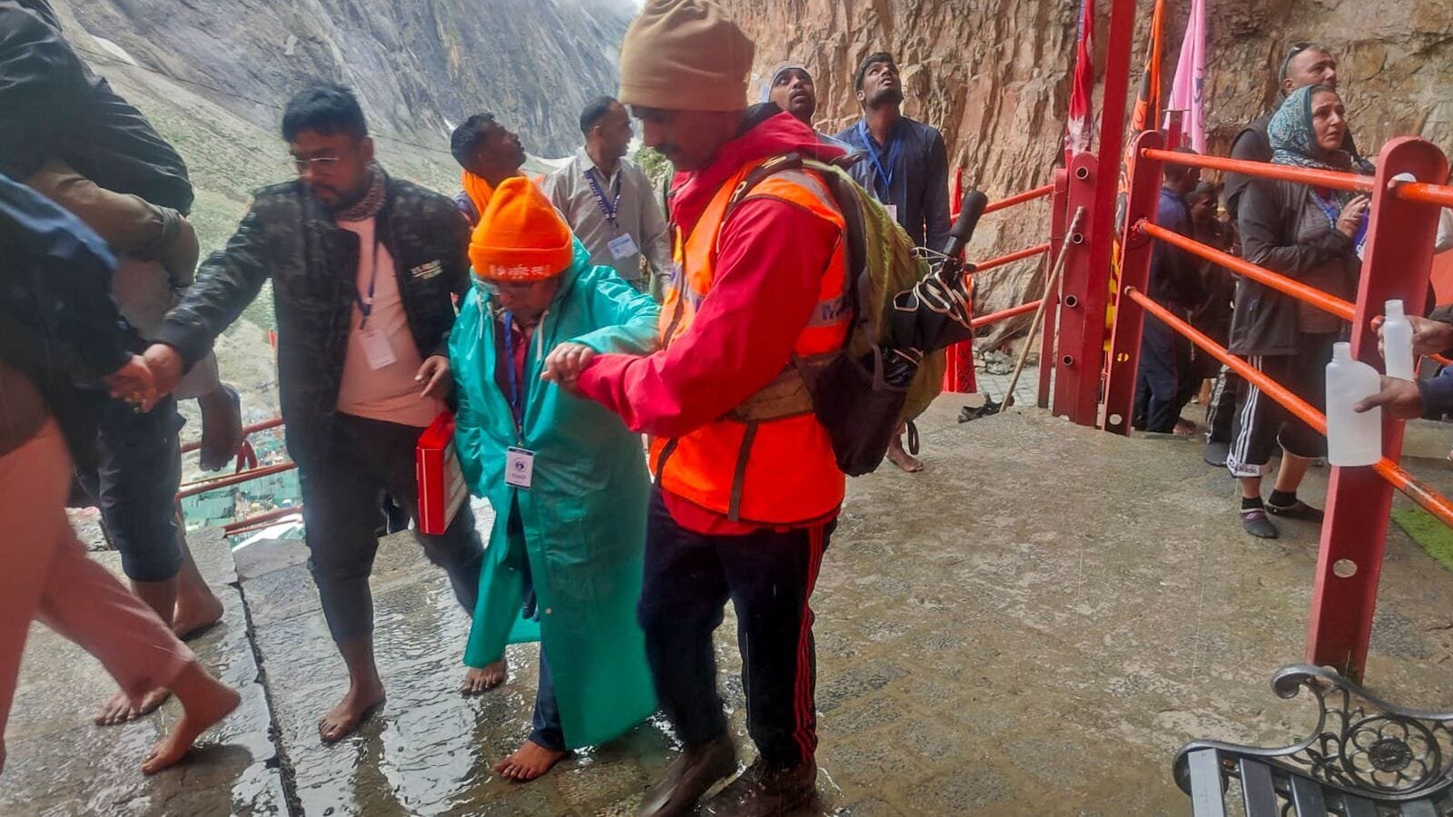 A member of Mountain Rescue Team (MRT) assists a pilgrim during the annual Amarnath Yatra