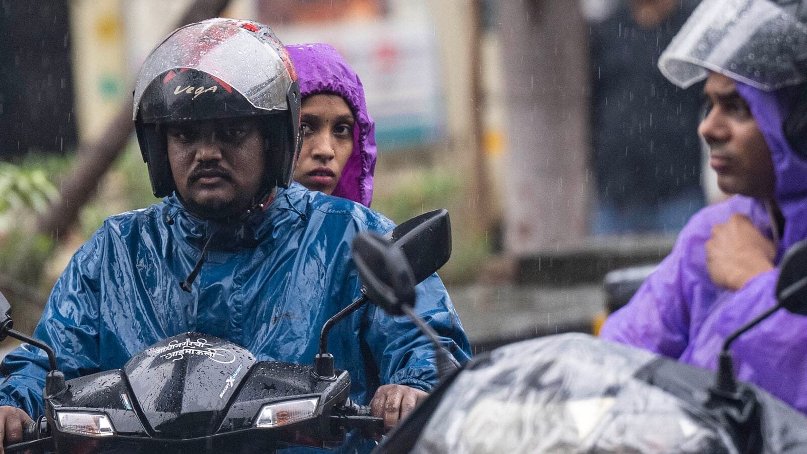 Mumbai, India - July 25, 2025:  People going through the rain at Andheri in Mumbai, India, on Friday, July 25, 2025.