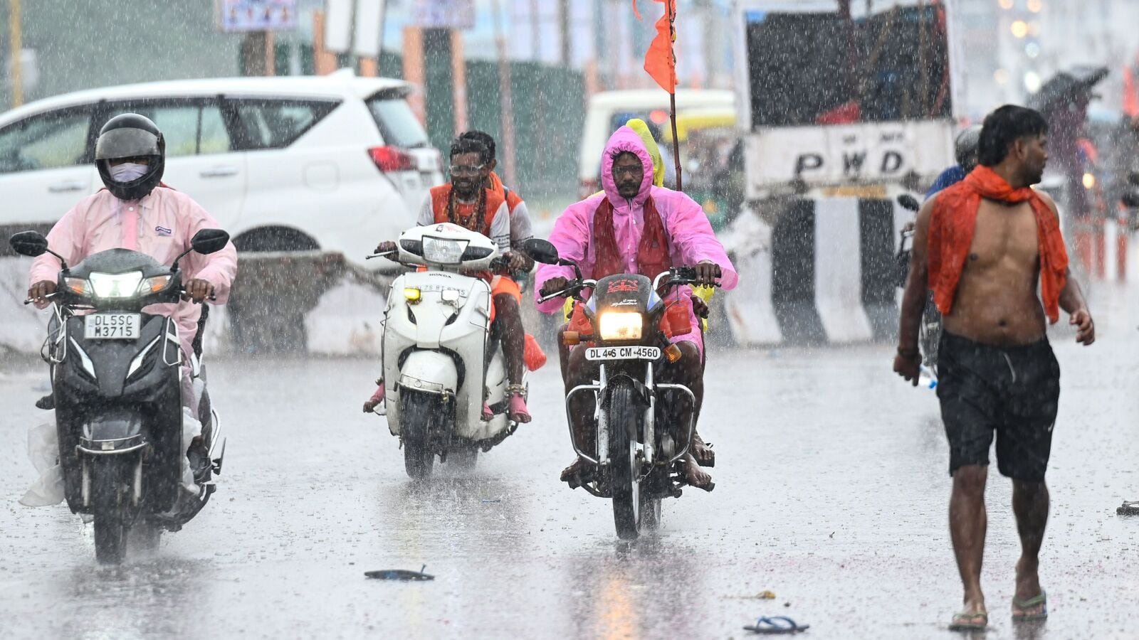 Commuters seen during sudden rains at Shastri Park in New Delhi, India, on Tuesday, July 22, 2025.  (Photo by Sanchit Khanna/ Hindustan Times)