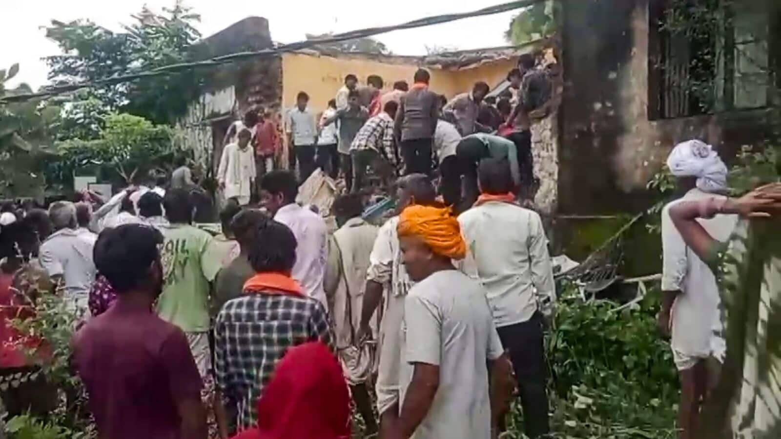 People assist during a rescue operation after a portion of a government school building collapsed, killing at least seven children, in Jhalawar district, Rajasthan, on Friday, July 25, 2025.