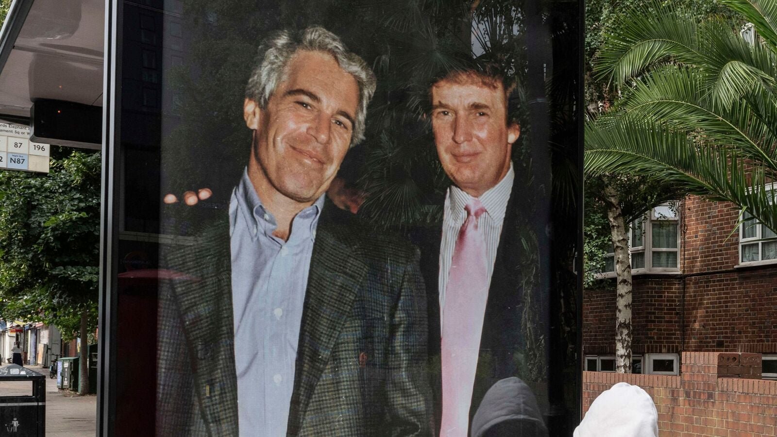Activists put up a poster showing President Donald Trump and Jeffrey Epstein near the U.S. Embassy in London, Thursday, July 17, 2025.(AP Photo/Thomas Krych)