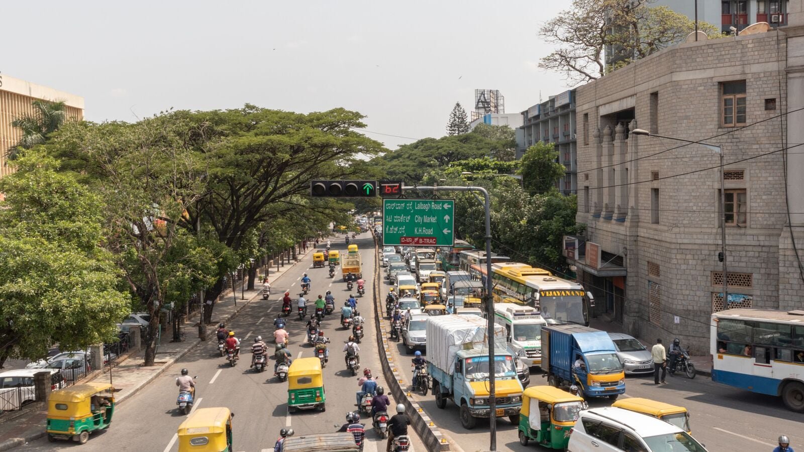 Aerial View of Green traffic light or signal with moving vehicle near Town hall Bengaluru, India.