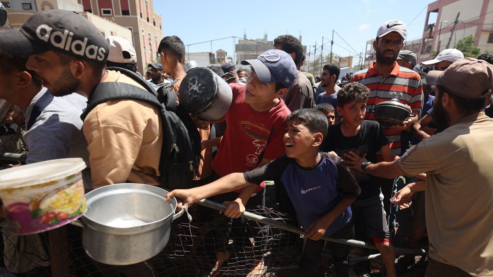 Palestinians gather at a food distribution point in the Nuseirat refugee camp in the central Gaza Strip on July 19, 2025. The World Food Programme said nearly one in three people in Gaza were not eating for days at a stretch and 'thousands' were 'on the verge of catastrophic hunger'. (Photo by Eyad BABA / AFP)