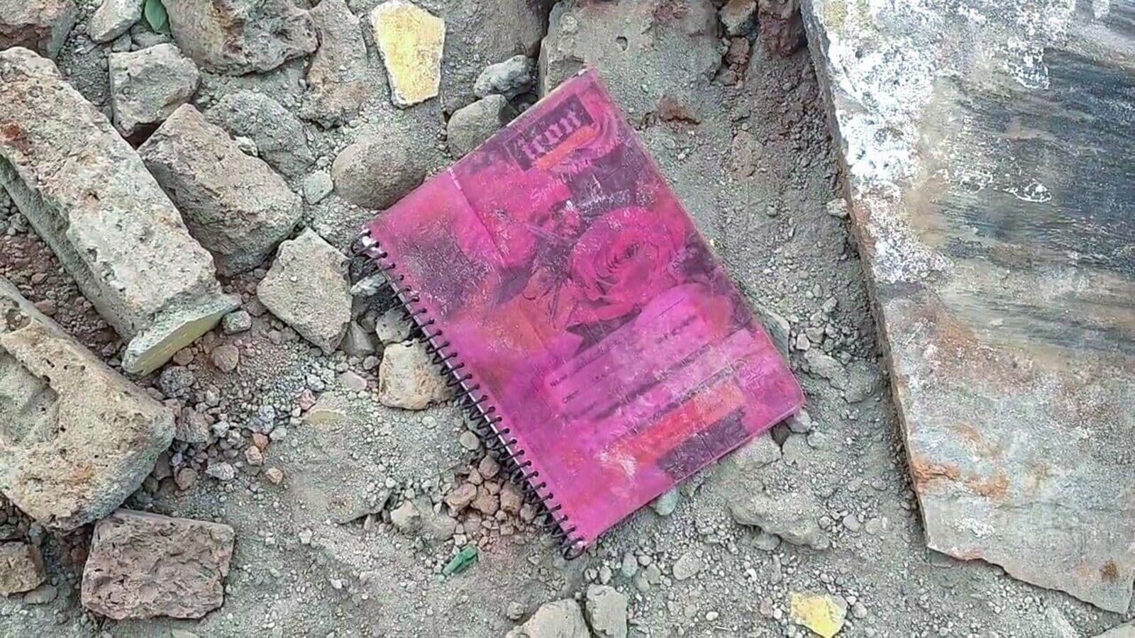 A book lies on the debris after the Piplodi Primary School building collapses, claiming the lives of seven students and injuring several others, in Jhalawar on Saturday. (ANI)