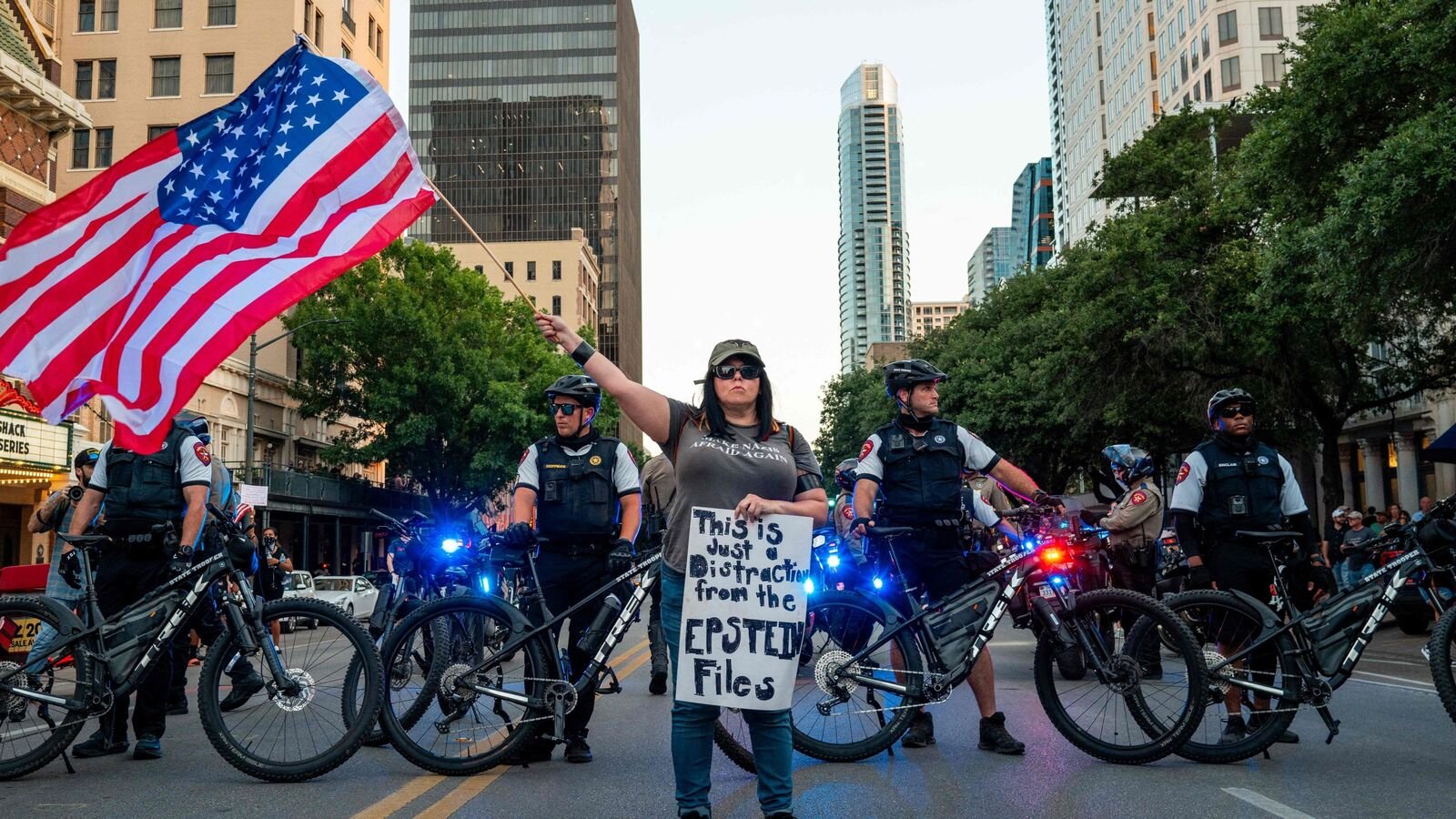 A protestor waves an American flag in the street as law enforcement work to secure an intersection during the the conclusion of the No Kings Day demonstration on June 14, 2025 in Austin, Texas. Brandon Bell/Getty Images/AFP. Representational image
