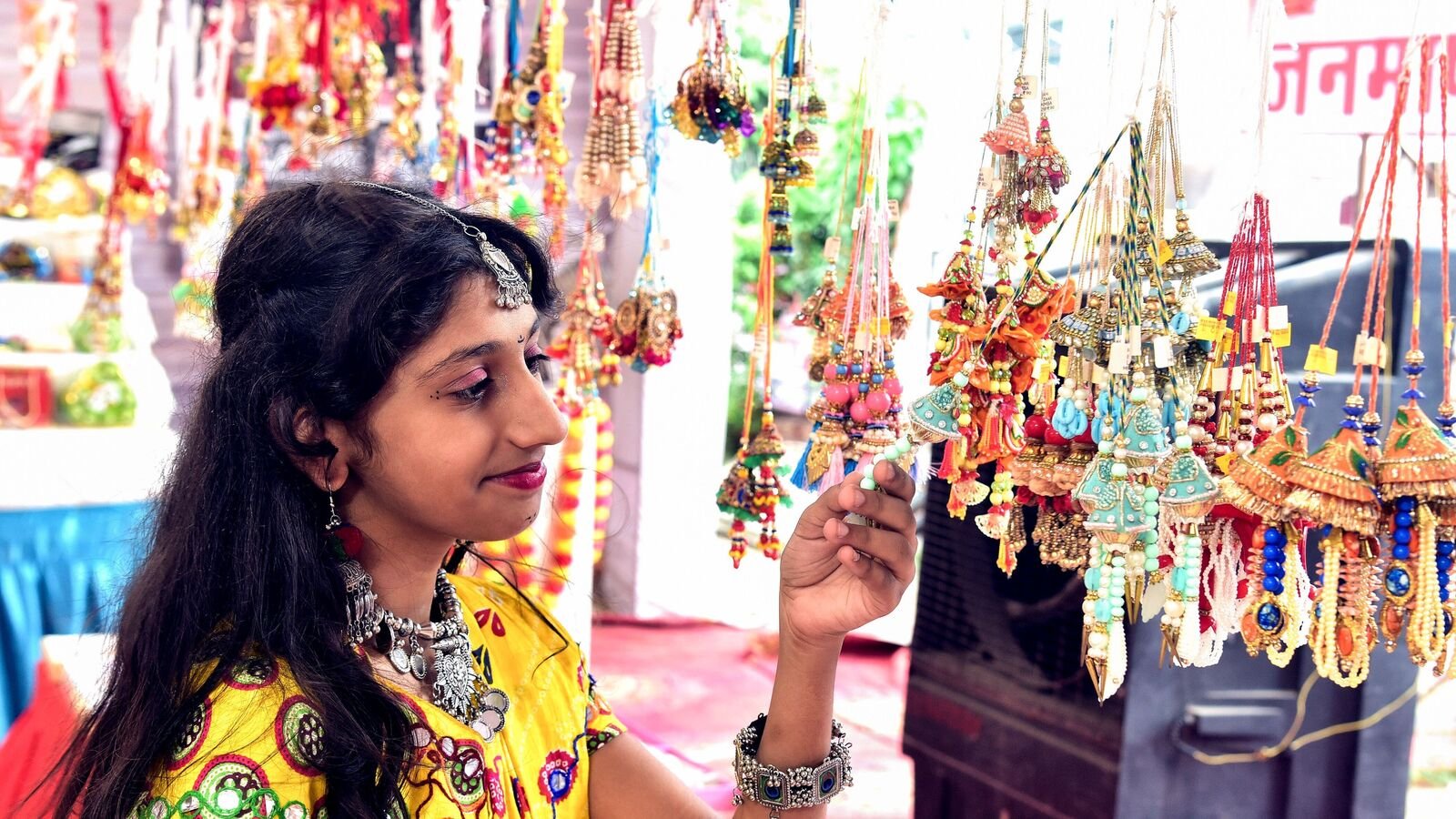 A girl shops for rakhis ahead of the Raksha Bandhan festival in Bikaner on Wednesday. (ANI Photo)