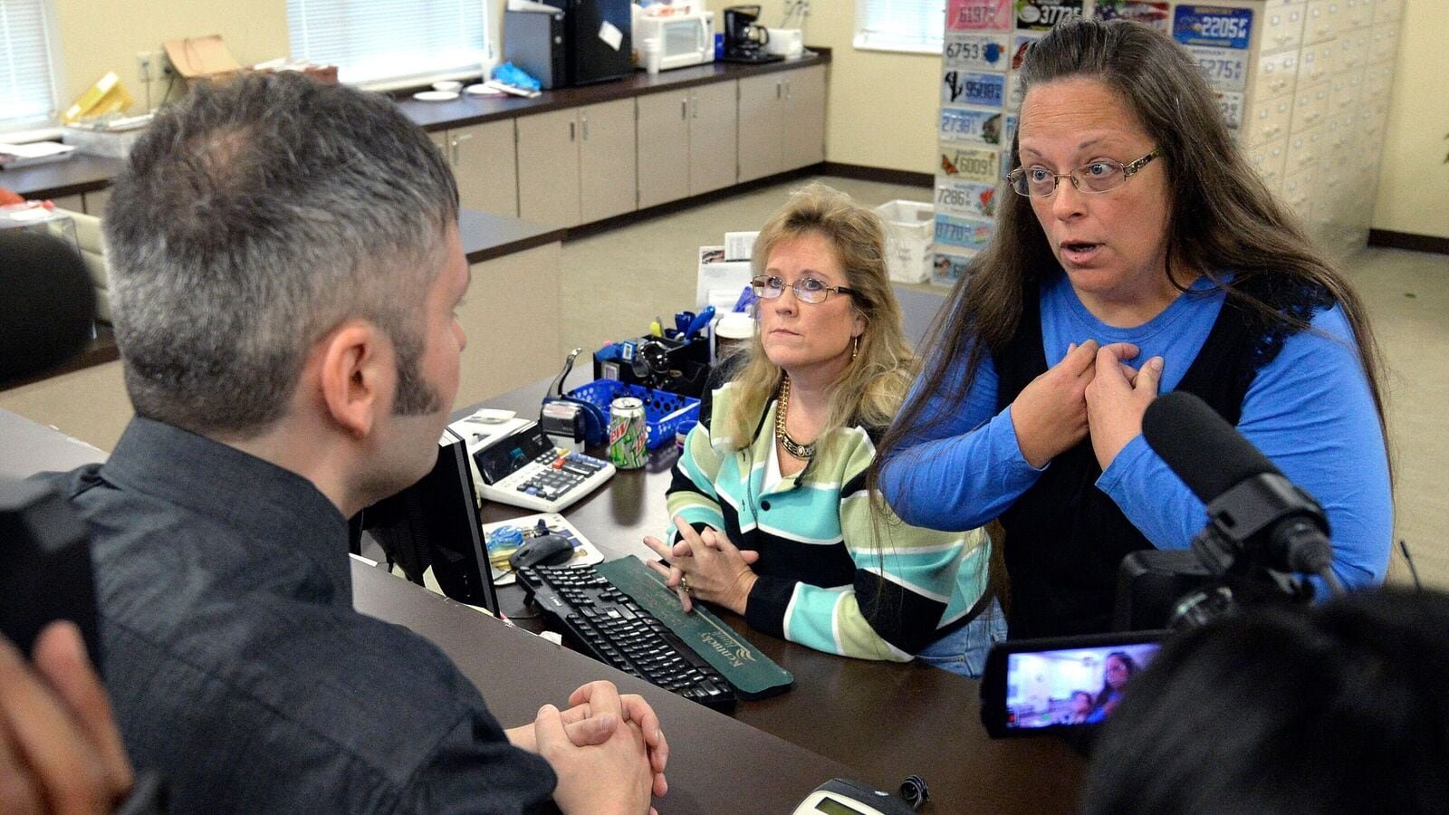 Rowan County Clerk Kim Davis, right, talks with David Moore following her office's refusal to issue marriage licenses at the Rowan County Courthouse in Morehead, Ky., on Sept. 1 2015. (AP Photo/Timothy D. Easley, File)