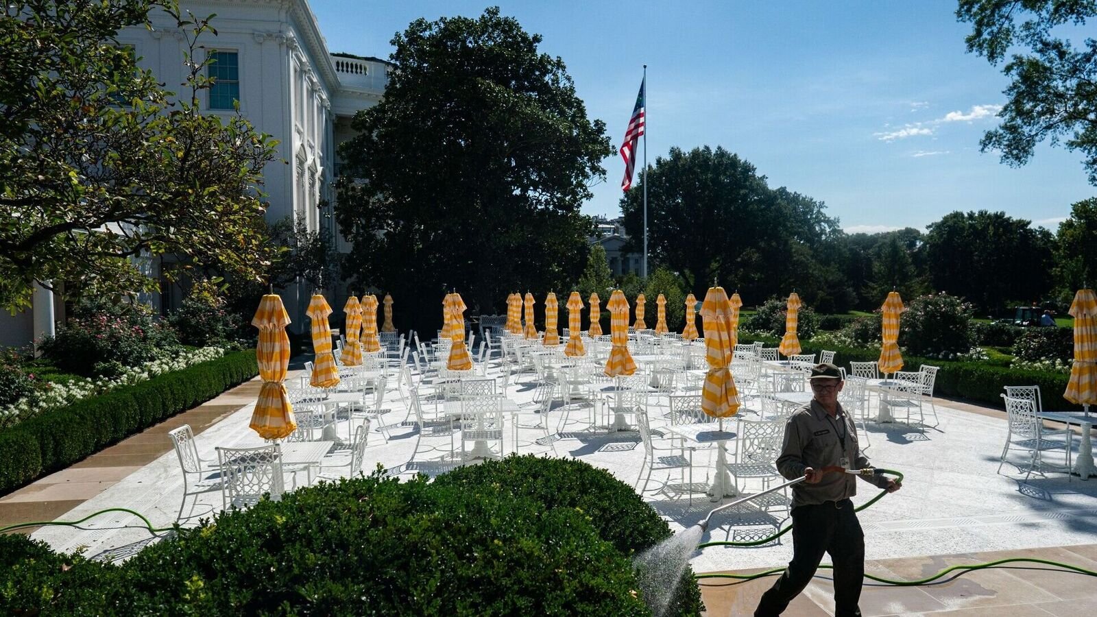 A worker with the National Park Service (NPS) waters plants near the newly renovated Rose Garden of the White House in Washington, DC, US, on Monday, Aug. 25, 2025. US President Donald Trump is expected to sign two executive orders Monday aiming to end cashless bail in Washington and nationwide, marking the latest move in the administration's agenda to crack down on crime. Photographer: Al Drago/Bloomberg