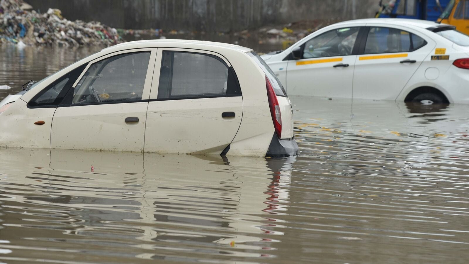 After heavy rains, Vehicles were stuck in a waterlogged vacant plot in Gurugram.(Photo by Parveen Kumar/Hindustan Times)