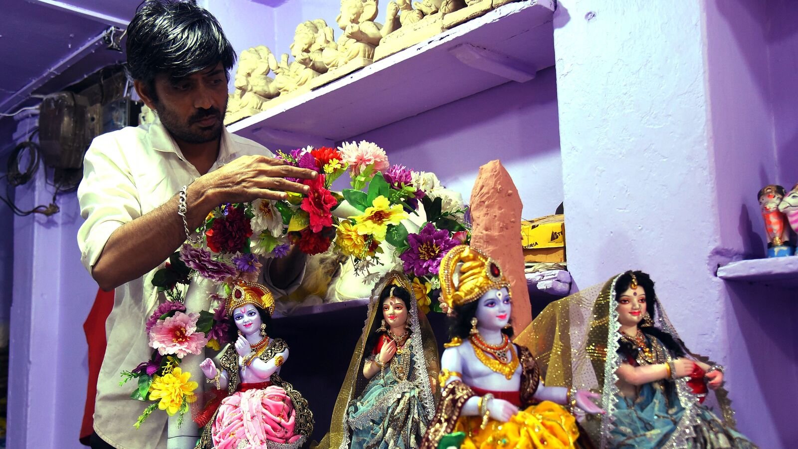 Janmashtami 2025: An artist puts the finishing touches on a Lord Krishna idol ahead of the Janmashtami festival in Nagpur.