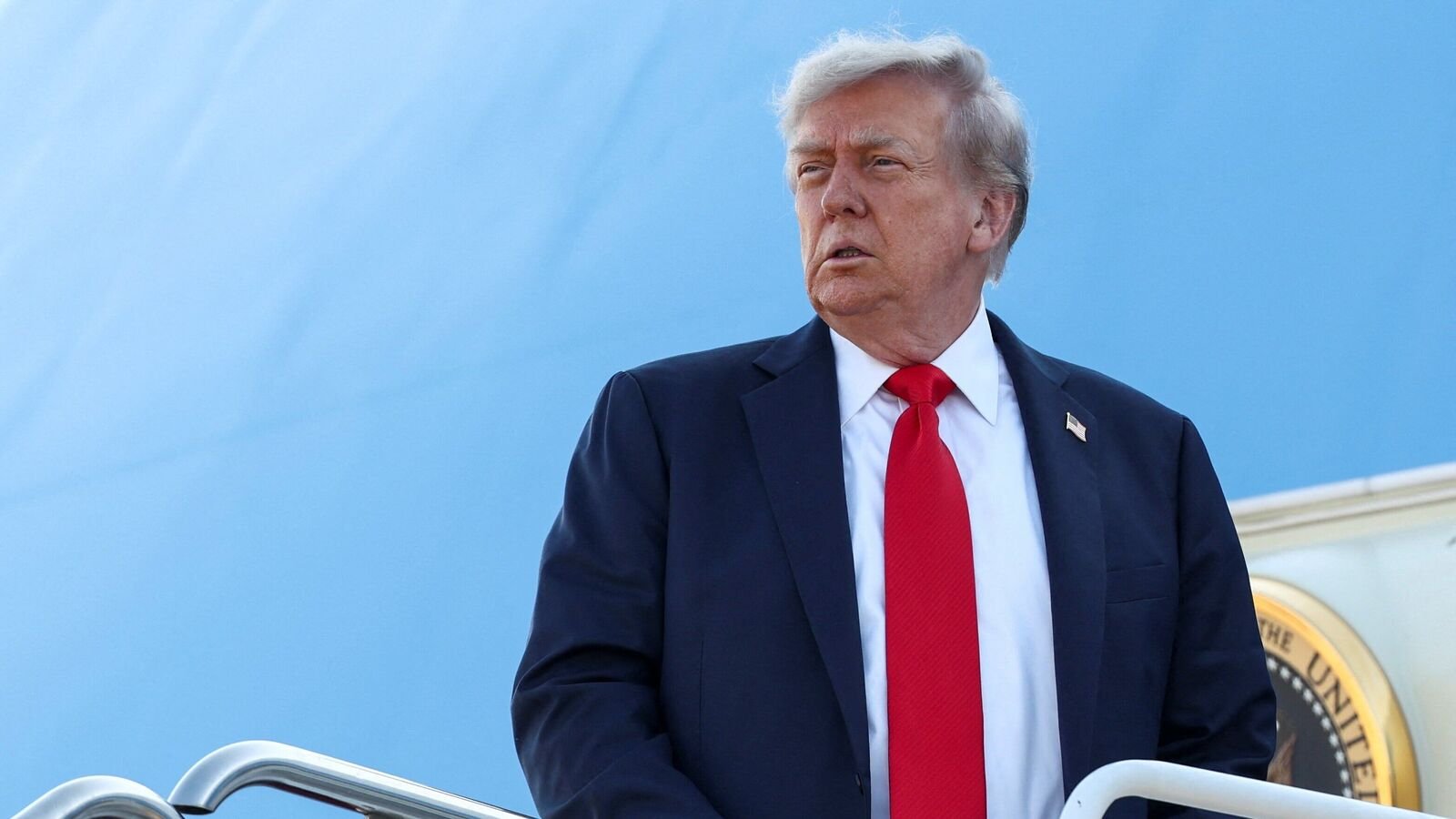 US President Donald Trump boards Air Force One as he departs for Alaska to meet with Russian President Vladimir Putin.