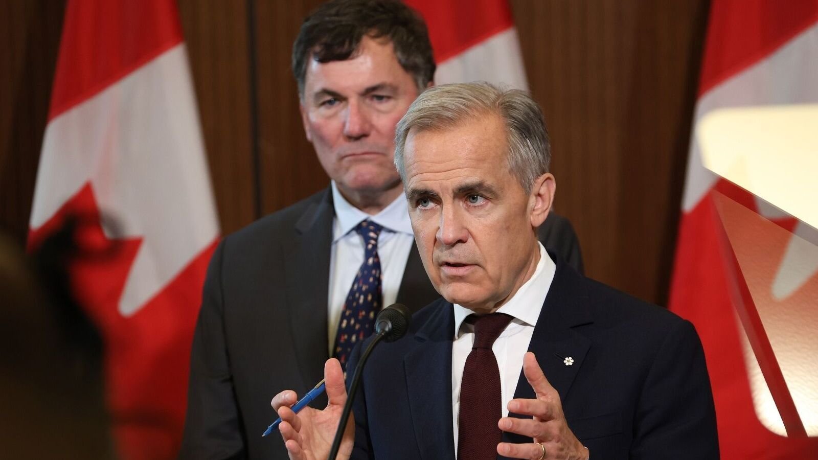 Mark Carney, Canada's prime minister, right, and Dominic LeBlanc, Canada's minister responsible for Canada-US trade. LeBlanc signaled optimism about reducing the newly imposed 35% US tariffs on Canadian goods not covered by USMCA. Photographer: David Kawai/Bloomberg/File photo