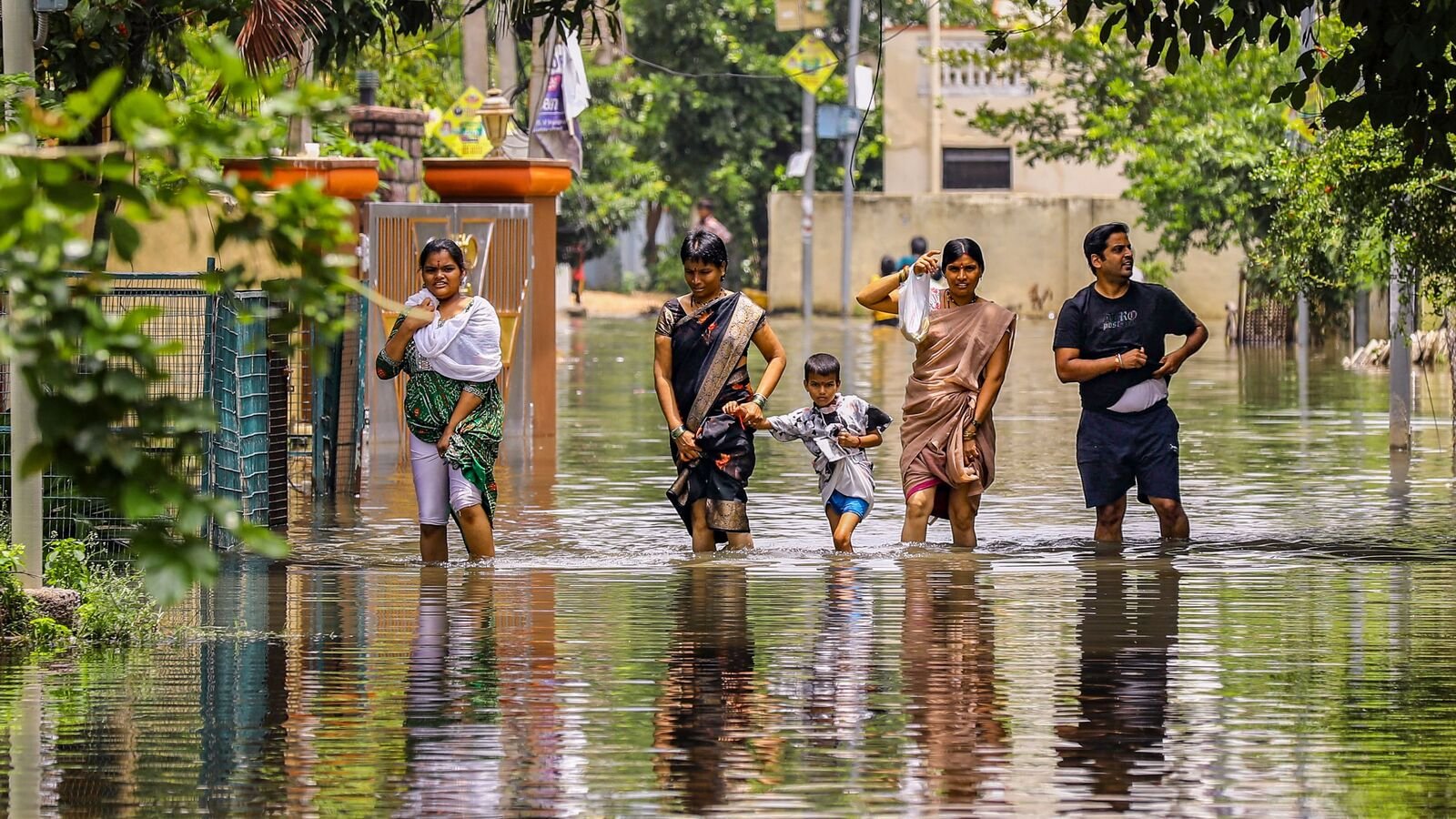 Hyderabad: People wade through a waterlogged road after heavy rainfall, at Mithali Nagar, Meerpet, Near Hyderabad, Telangana, Sunday, Aug. 10, 2025. (PTI Photo)