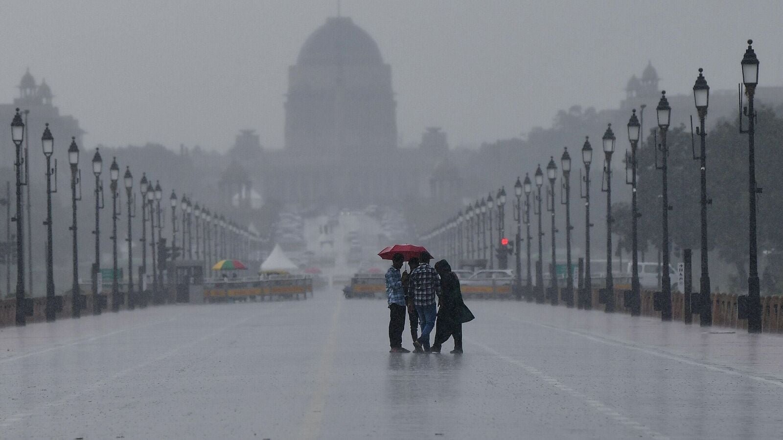New Delhi, Aug 01 (ANI): People enjoy the rain at Kartavya Path, in New Delhi on Friday. (ANI Photo/ Rahul Singh)