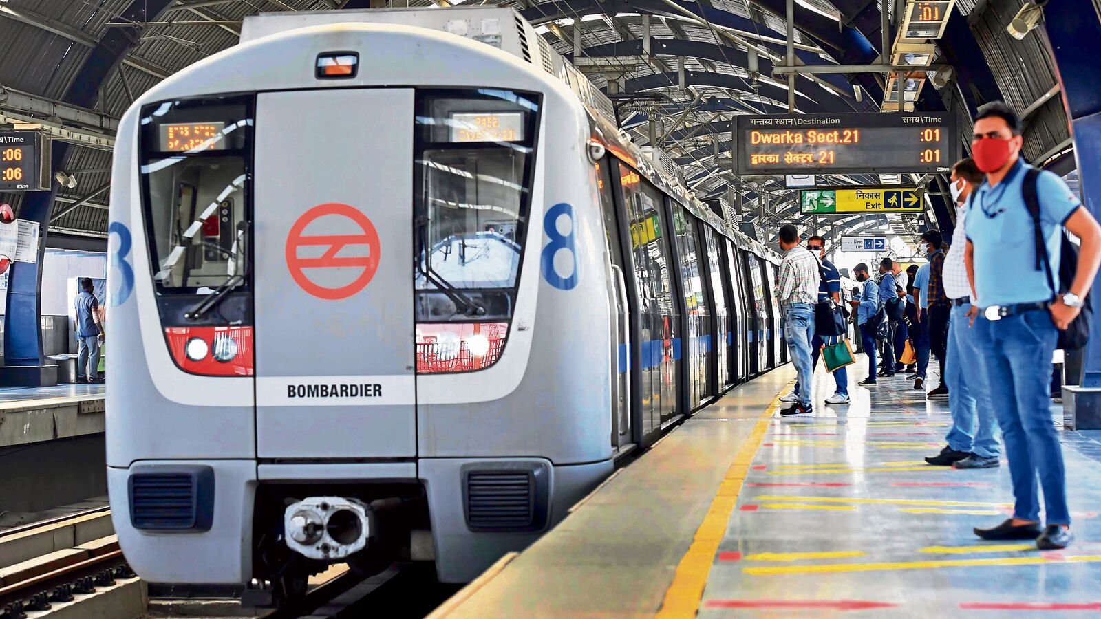 Commuters seen at a Metro platform, in New Delhi