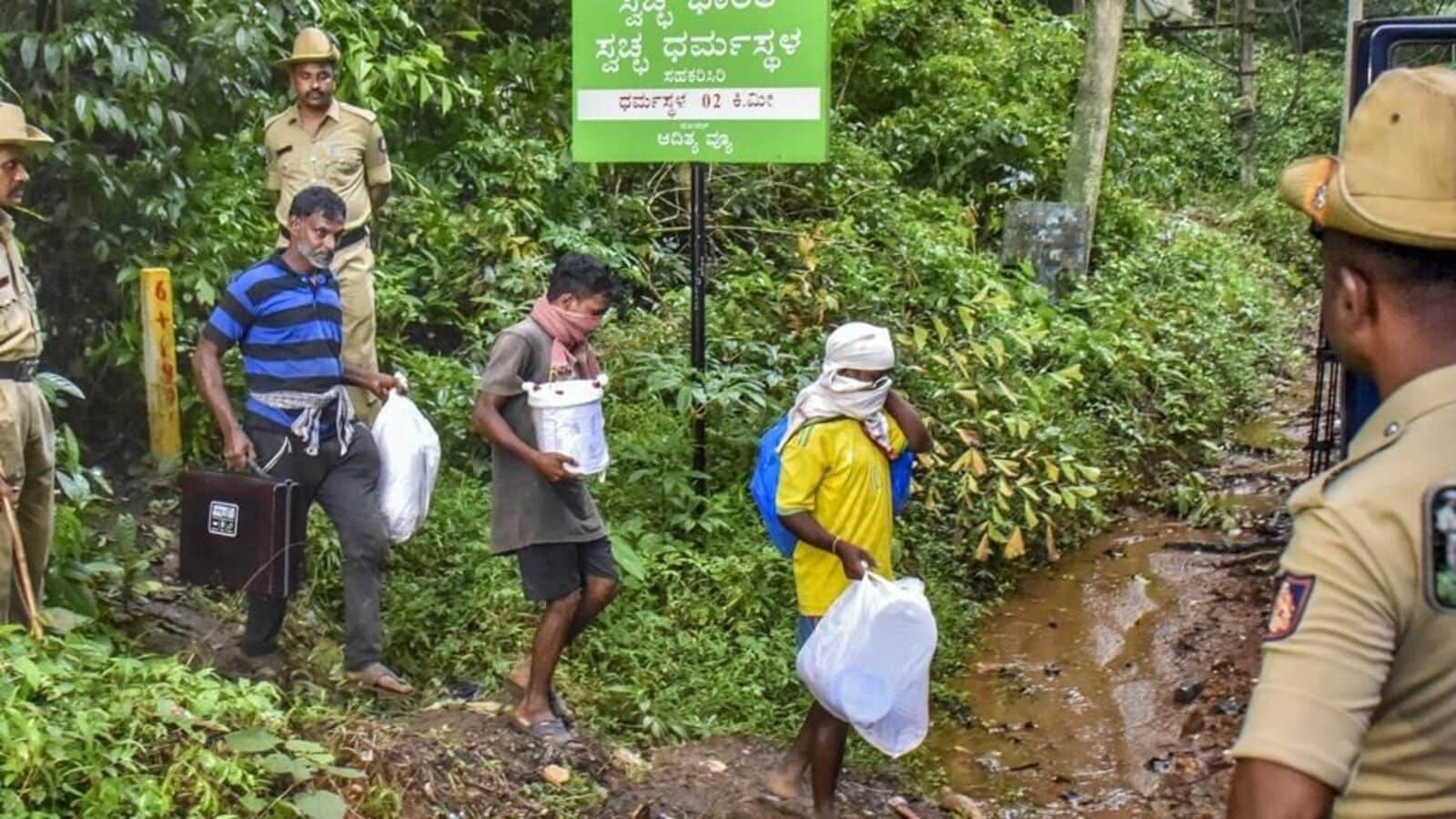 Workers leave from a site of an alleged burial related to the Dharmasthala mass burial case, at Dharmasthala, in Dakshina Kannada district.