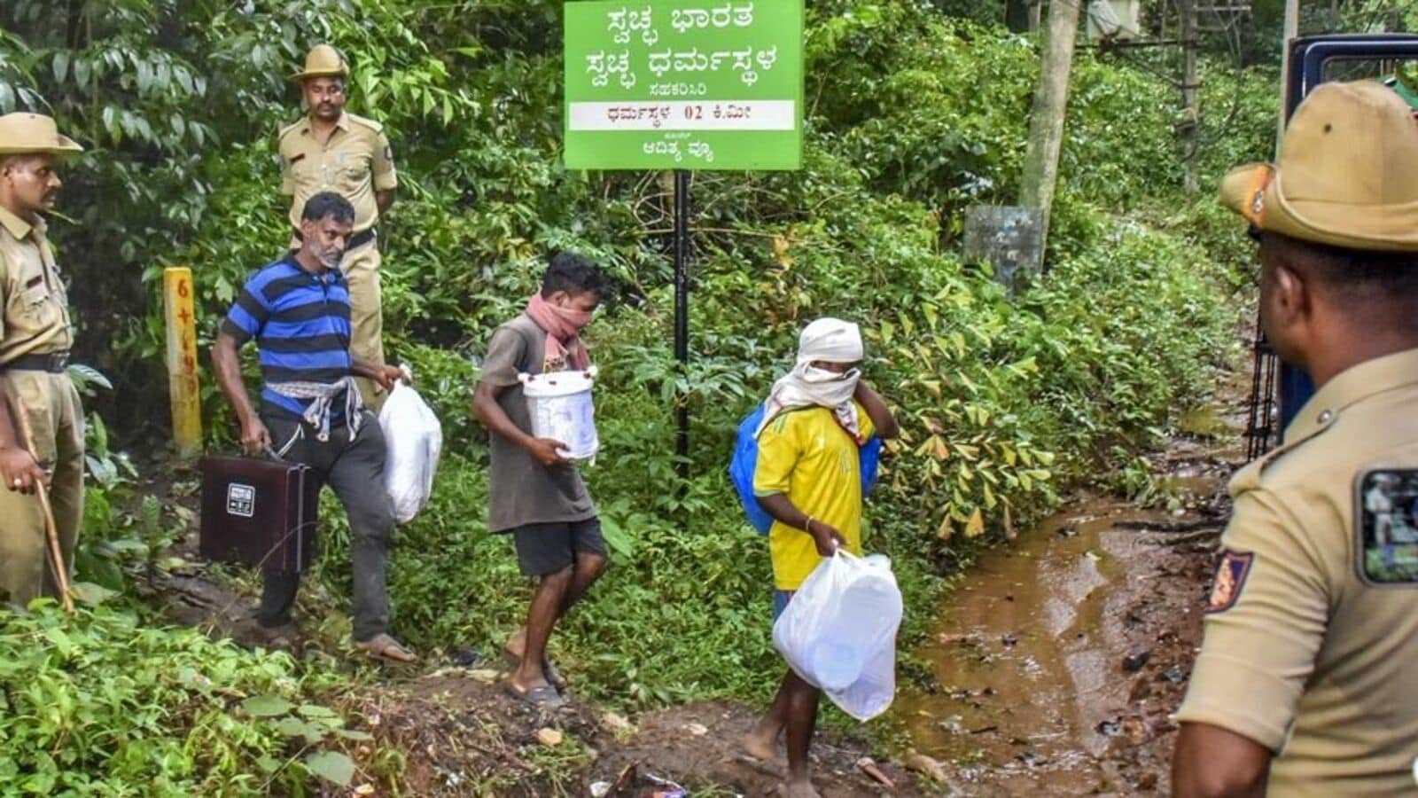 Workers leave from a site of an alleged burial related to the Dharmasthala mass burial case, at Dharmasthala, in Dakshina Kannada district, on Monday. (PTI)