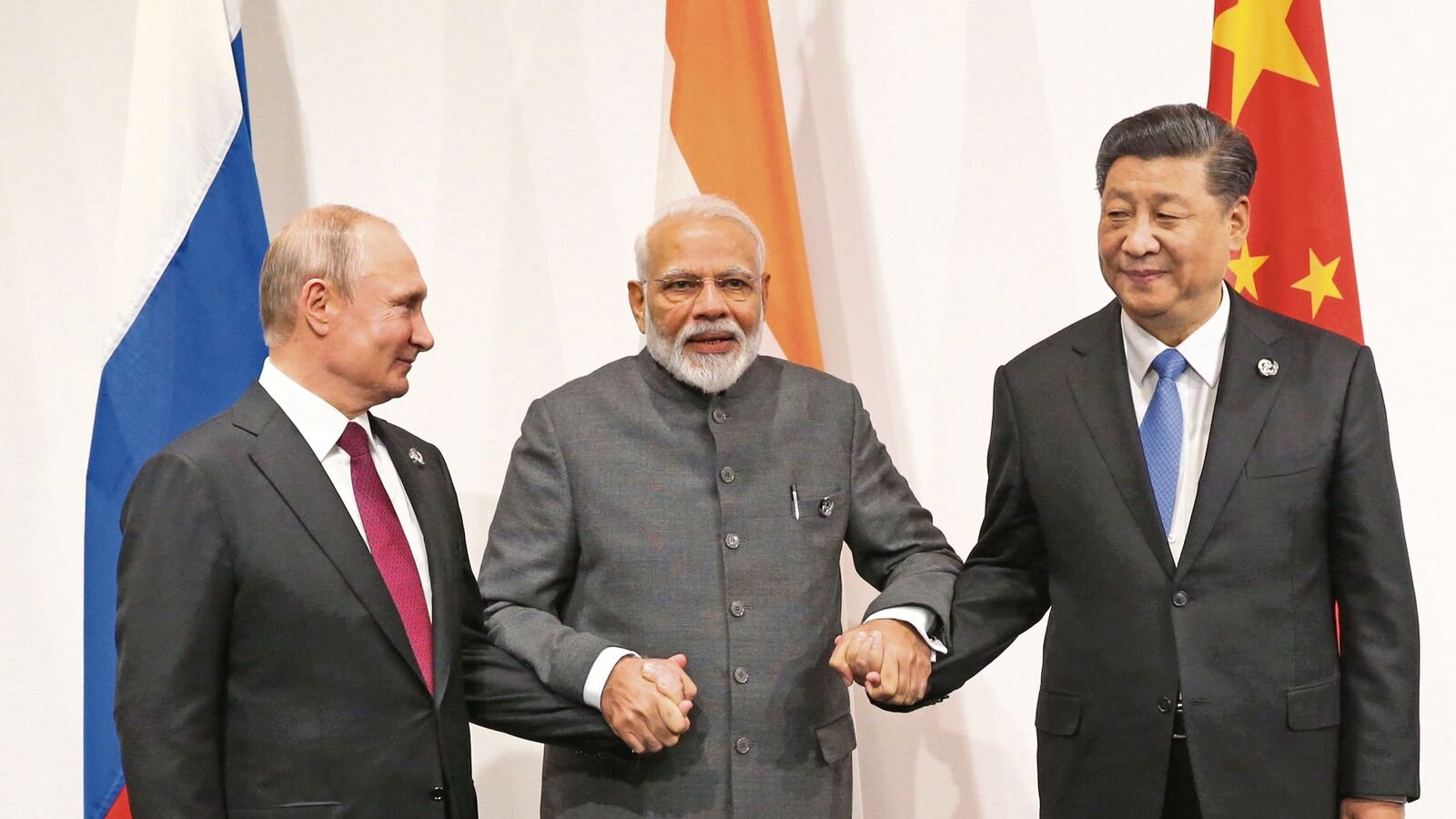 Prime Minister Narendra Modi (C) and Chinese President Xi Jinping (R) pose for a group photo prior to their trilateral meeting at the G20 Osaka Summit in JUne 2019