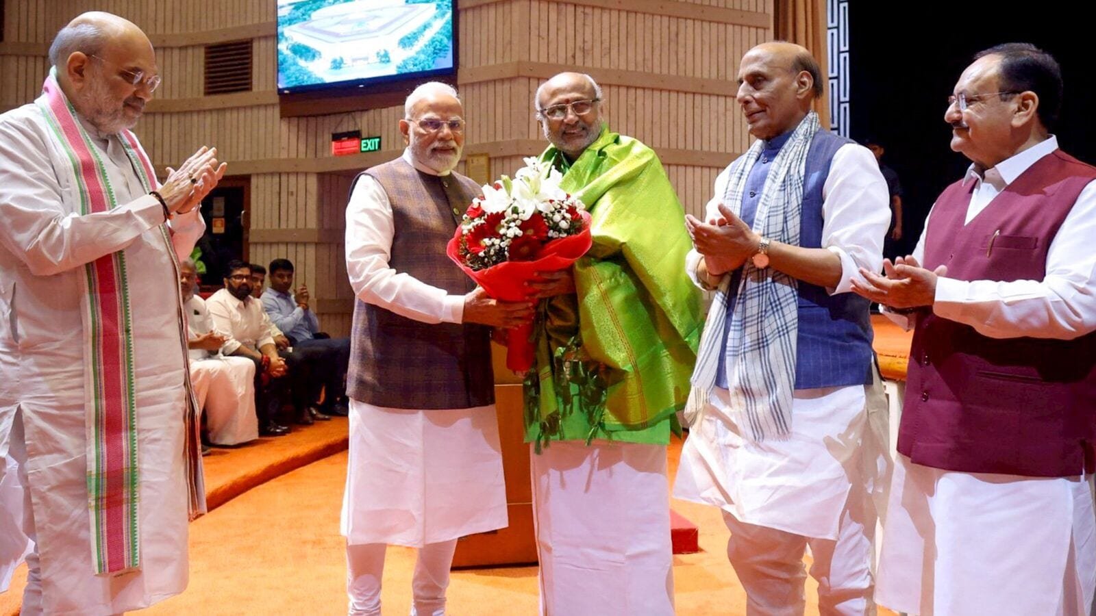 Prime Minister Narendra Modi felicitates Maharashtra Governor and NDA's vice presidential candidate CP Radhakrishnan during the NDA parliamentary party meeting