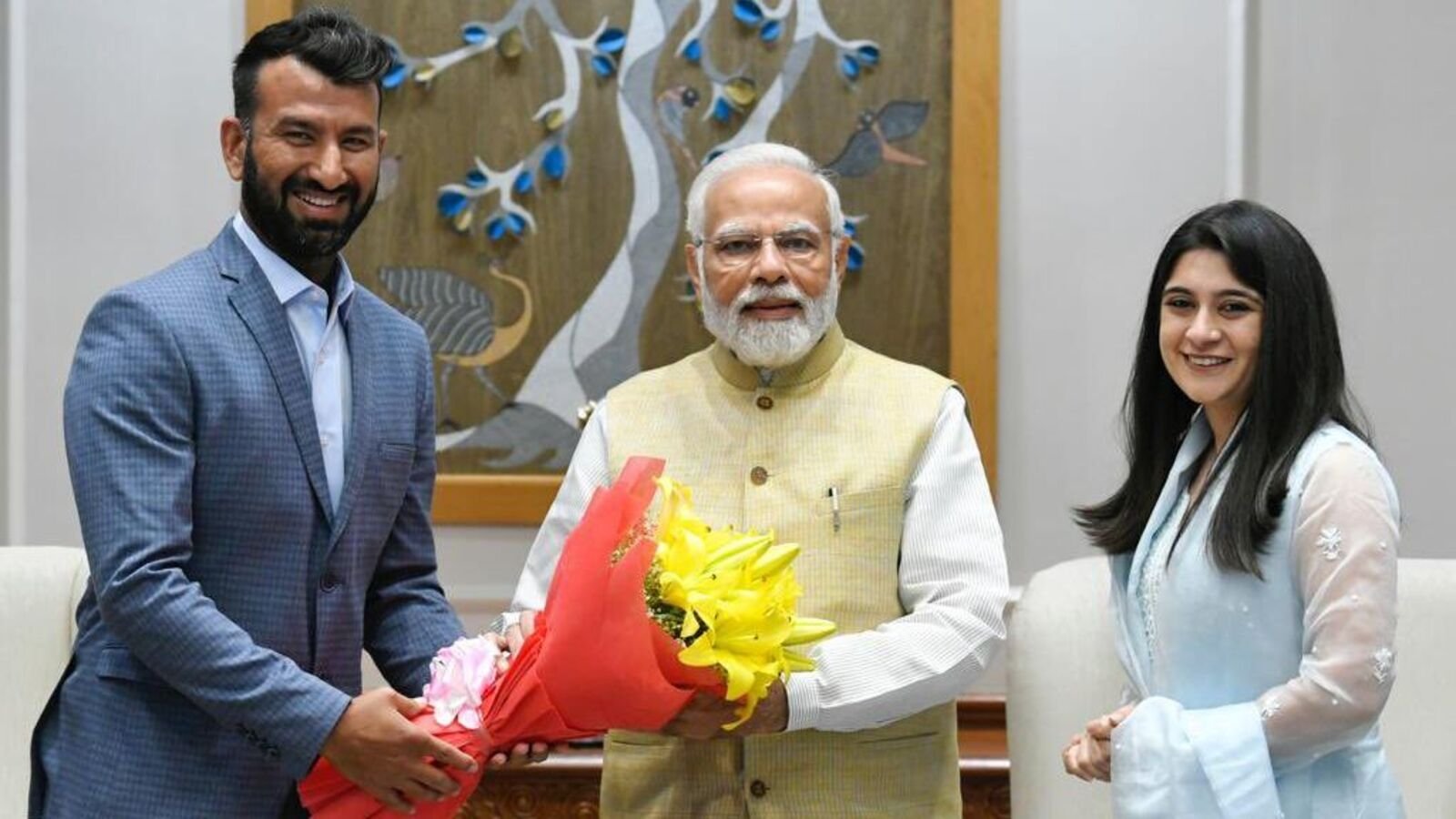 Cheteshwar Pujara (L) and his wife Puja (R) with PM Narendra Modi.