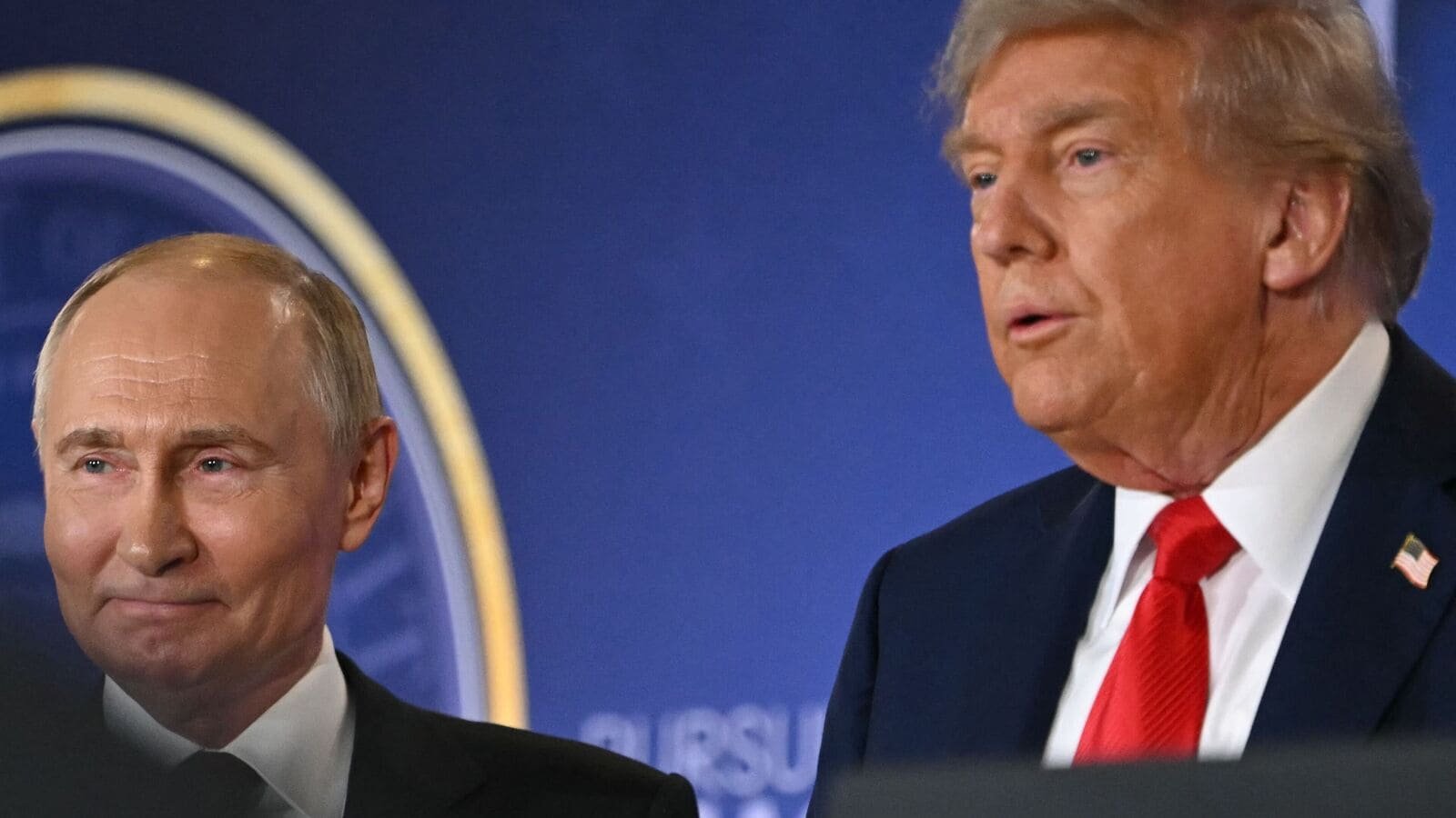 US President Donald Trump (R) and Russian President Vladimir Putin stand together after delivering a joint press conference after participating in a US-Russia summit on Ukraine