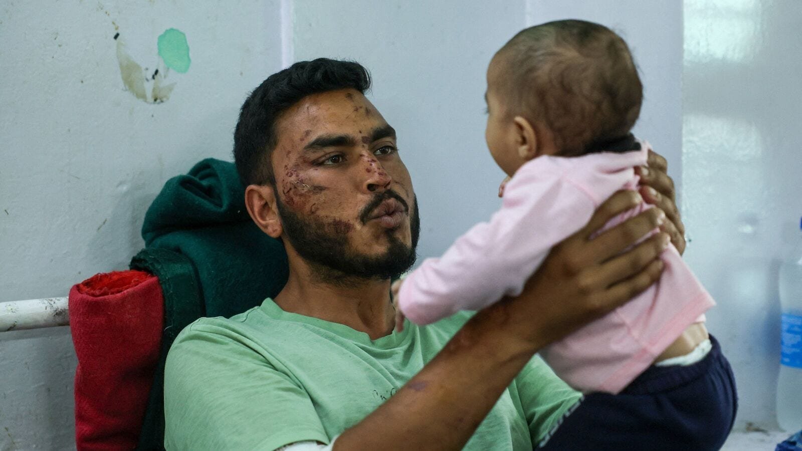 Gopal, an army member who was rescued from Dharali village after it was hit by landslides, plays with his child as he recovers at a district hospital in Uttarkashi, Uttarakhand, India, August 7, 2025. REUTERS/Francis Mascarenhas