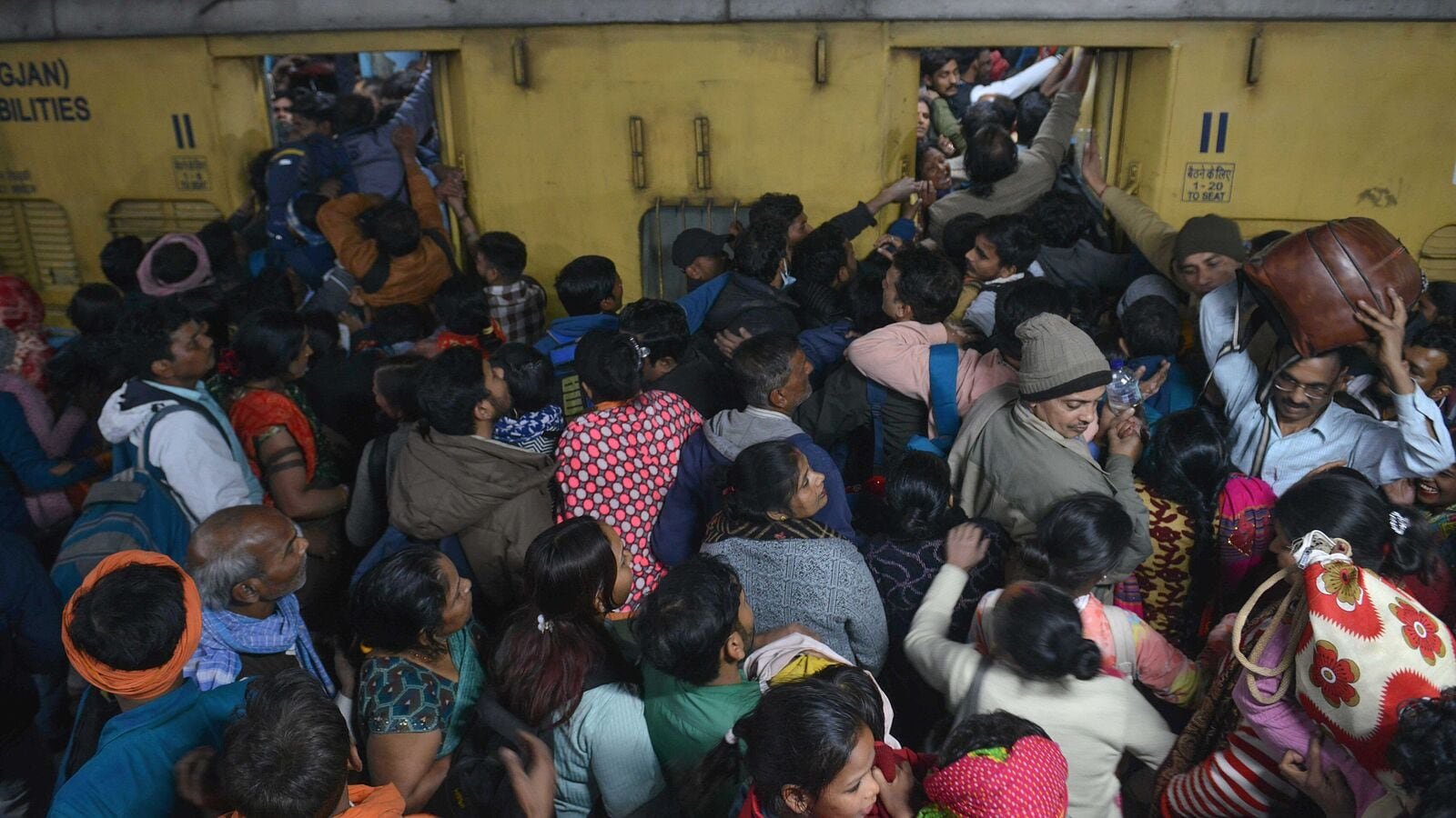 Passengers jostle with each other to board a train after a stampede at the New Delhi Railway station, in New Delhi India on February 16,2025,