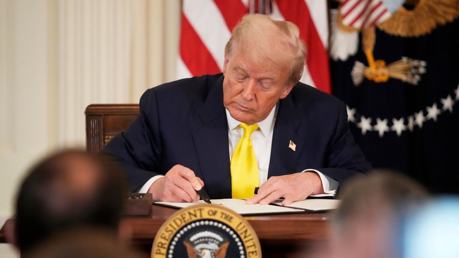 President Donald Trump signs a proclamation declaring National Purple Heart Day in the East Room of the White House, Thursday, Aug. 7, 2025, in Washington.