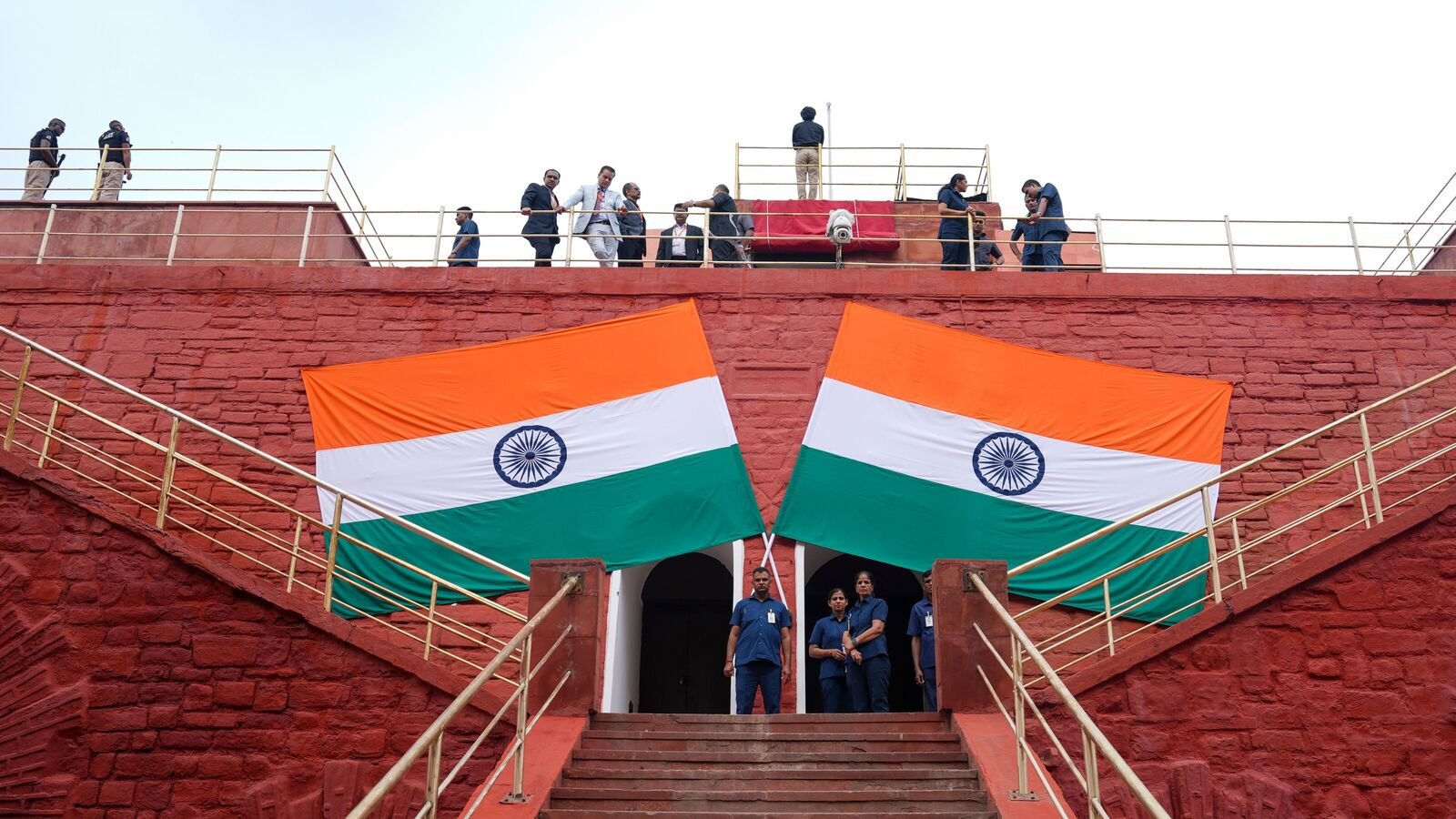 Security personnel and officials rehearse for the 79th Independence Day celebrations at the Red Fort complex in New Delhi on Wednesday.